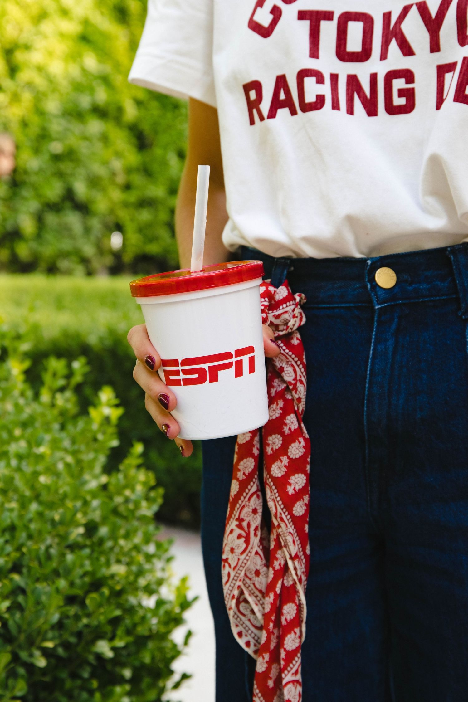 Close-up of sports jerseys and branded apparel at an outdoor event.