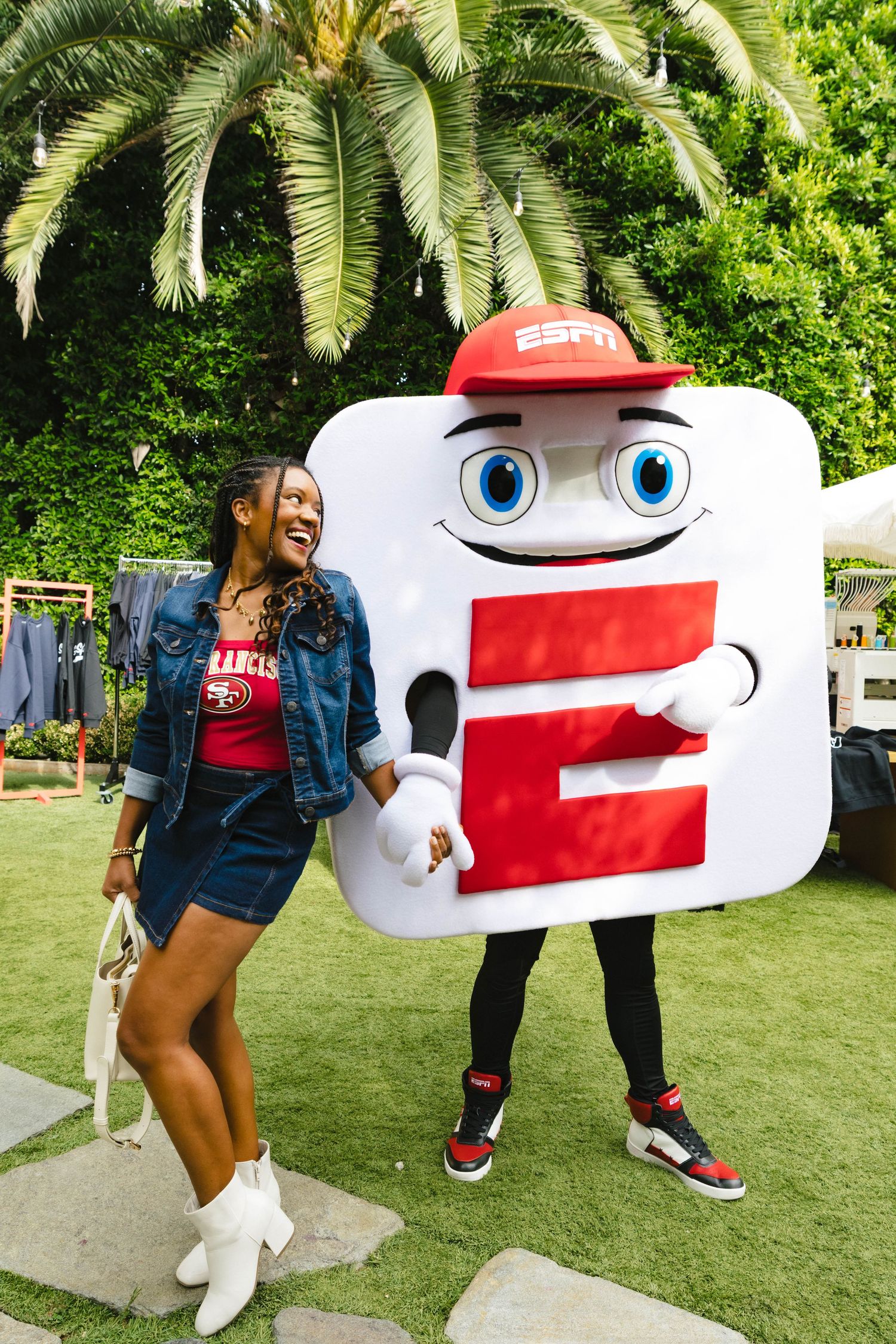 ESPN mascot character interacting with attendees at outdoor event.
