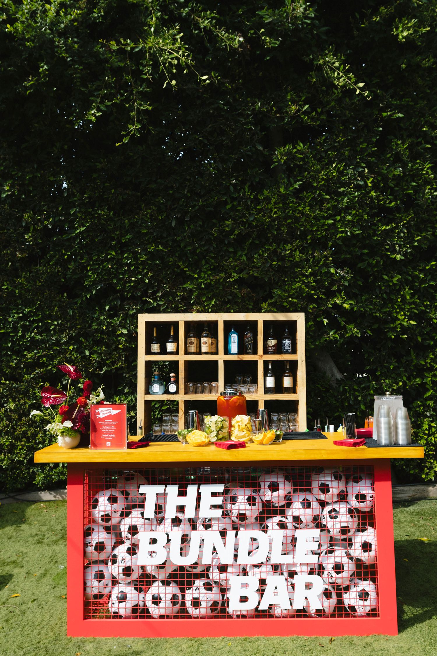 The Bundle Bar setup with soccer ball pattern backdrop and wooden shelving.