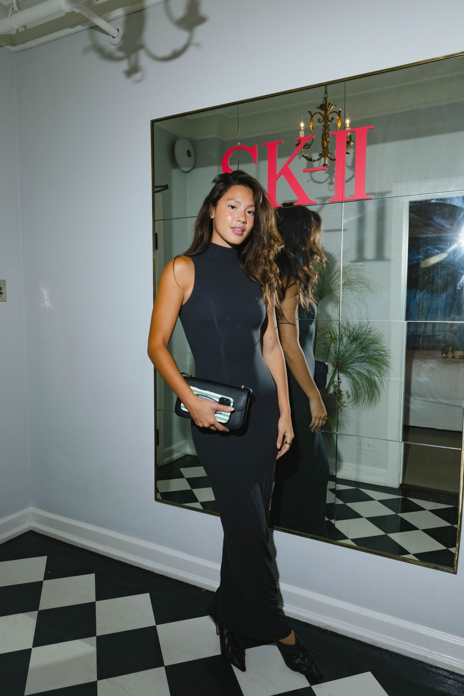 Elegant interior with black and white checkered floor and SK-II branding.