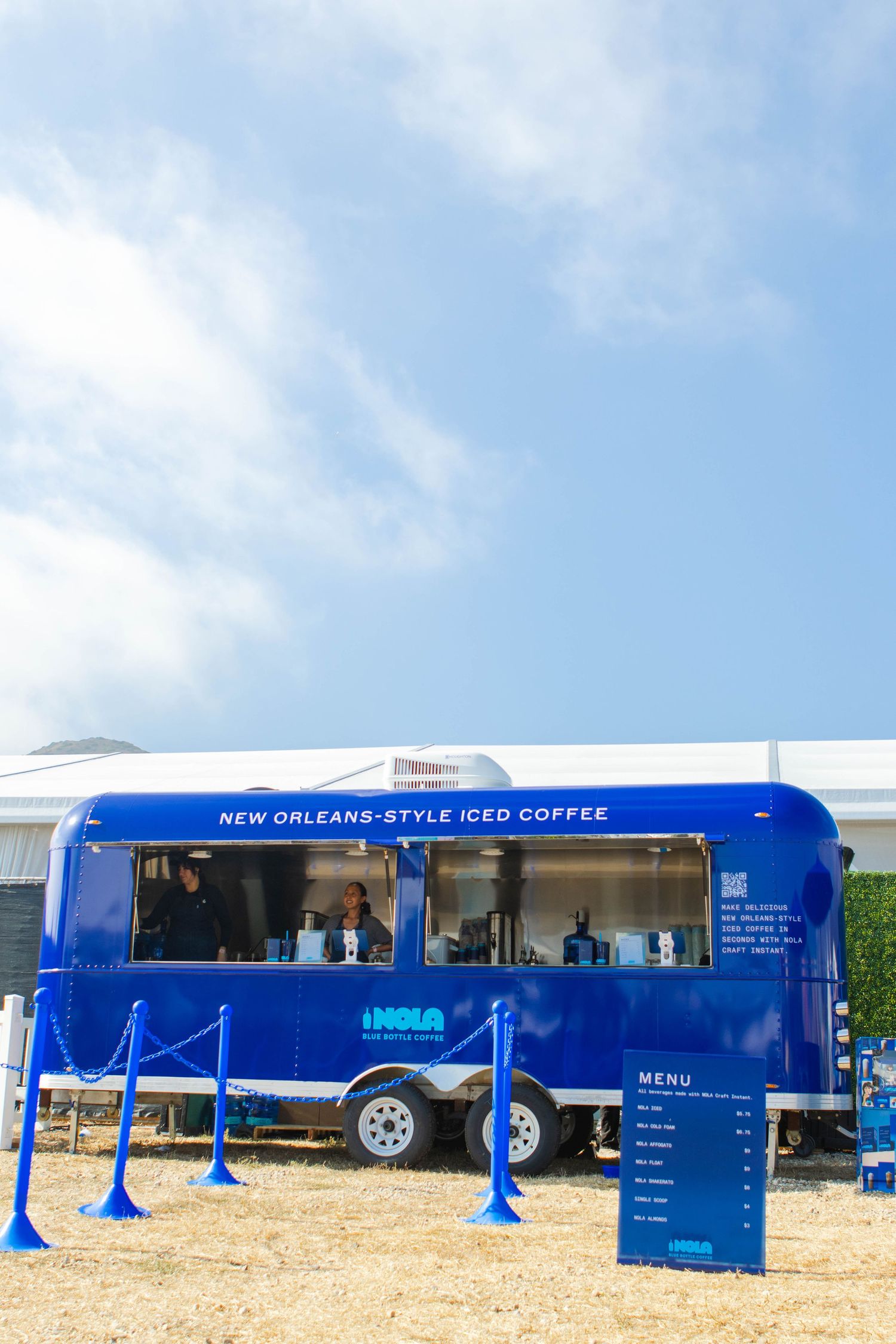 Blue food truck serving New Orleans style iced coffee with outdoor menu display.