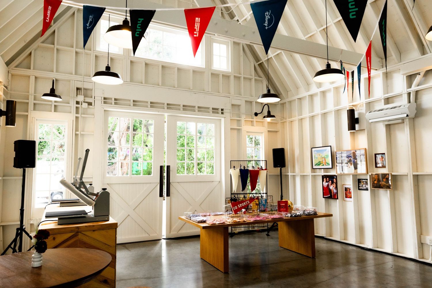 Large white indoor event space decorated with red, white and blue bunting.