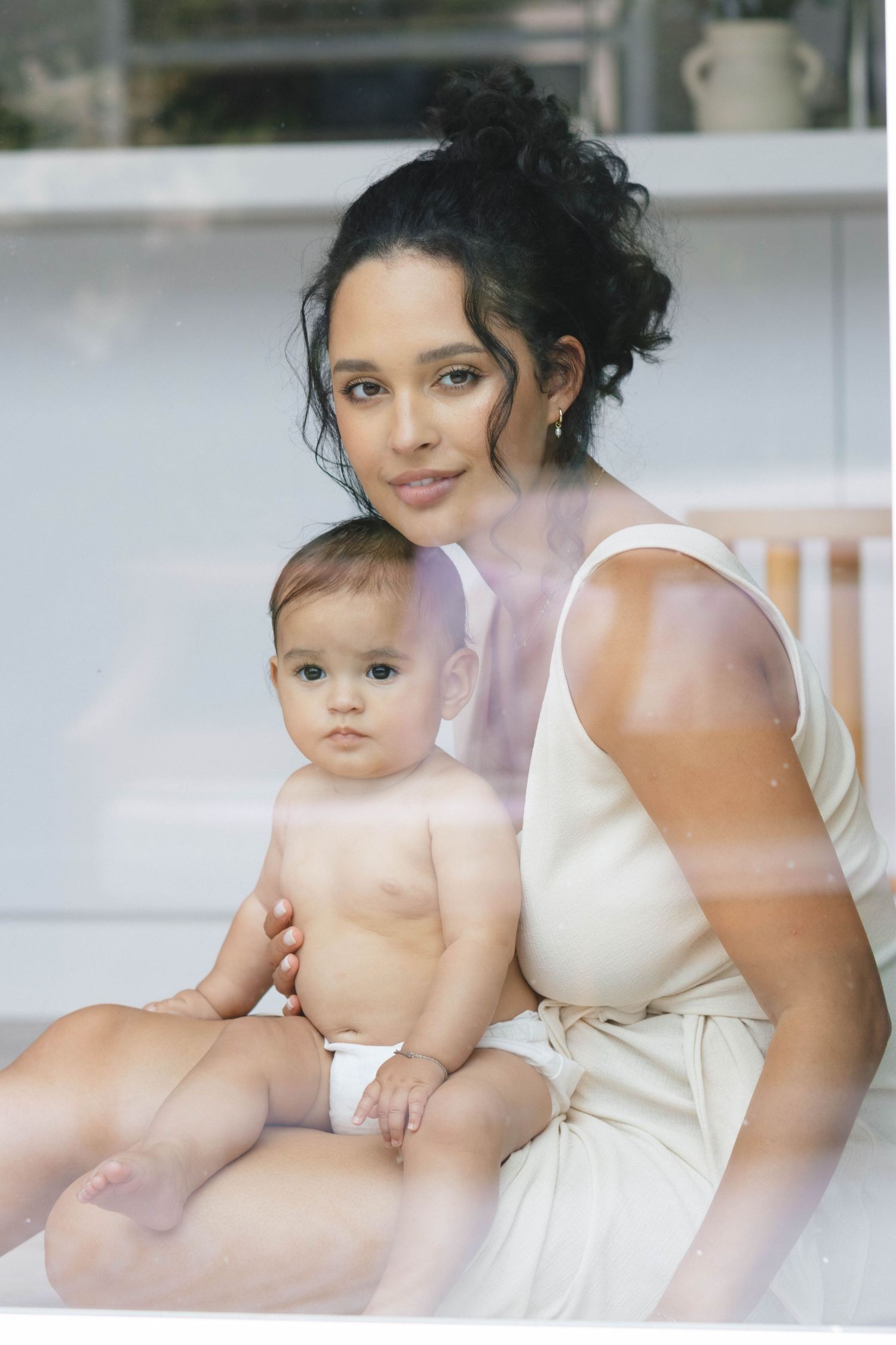 Intimate portrait series in natural light showing tender maternal moments.