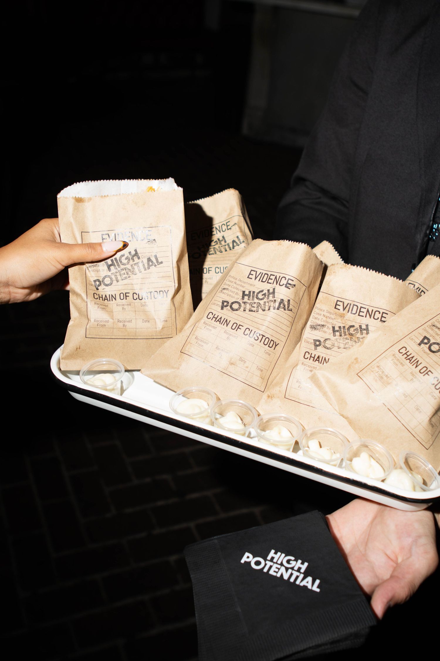Collection of brown paper evidence bags arranged on dark surface.