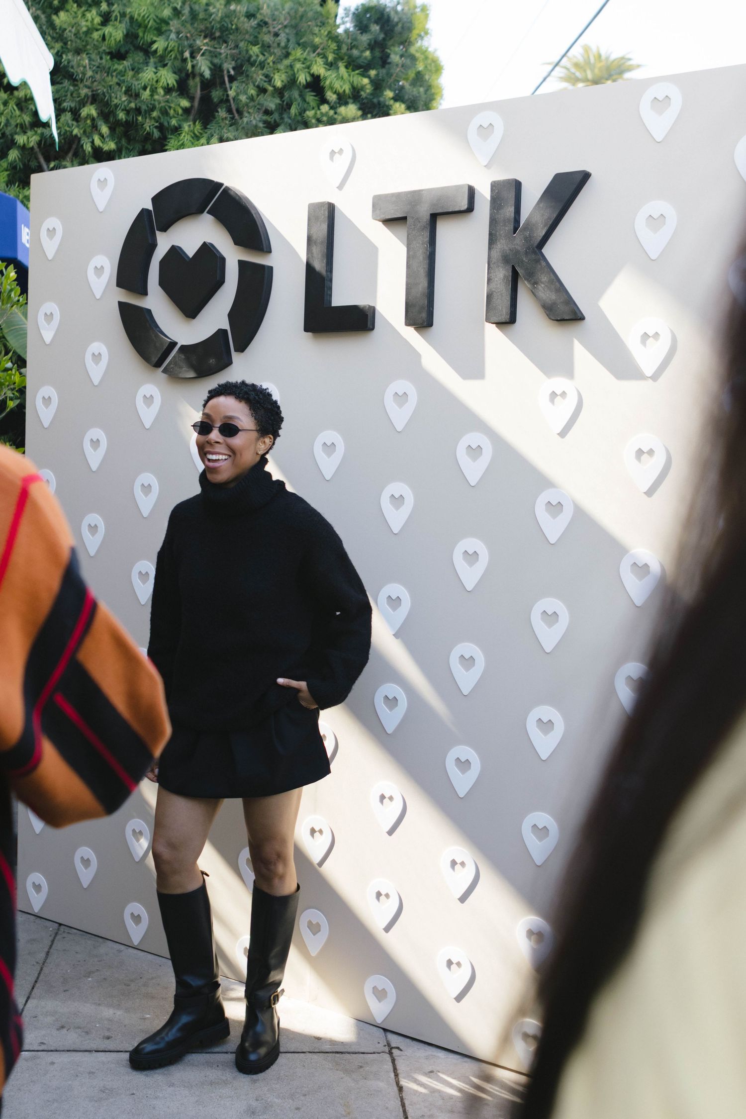 LTK logo wall display with heart pattern background at promotional event.