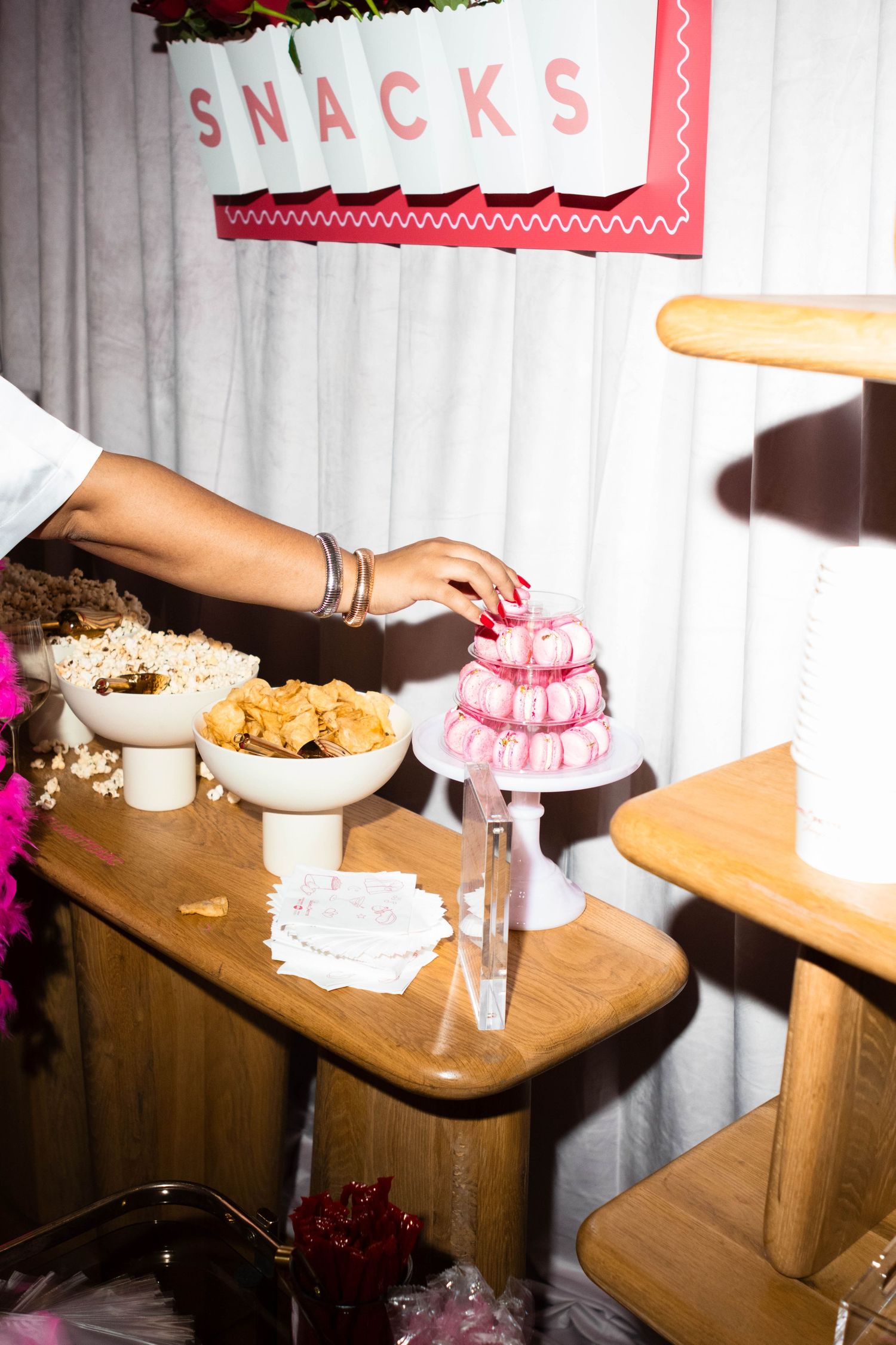 Snack table setup with treats and decorations at an event.