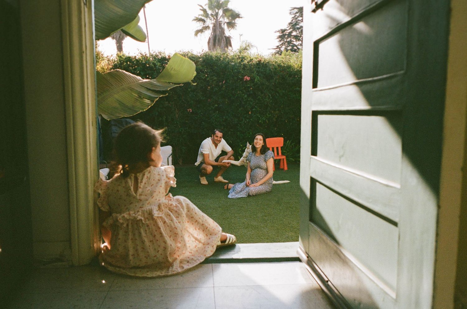 Casual outdoor gathering with people relaxing on a patio.