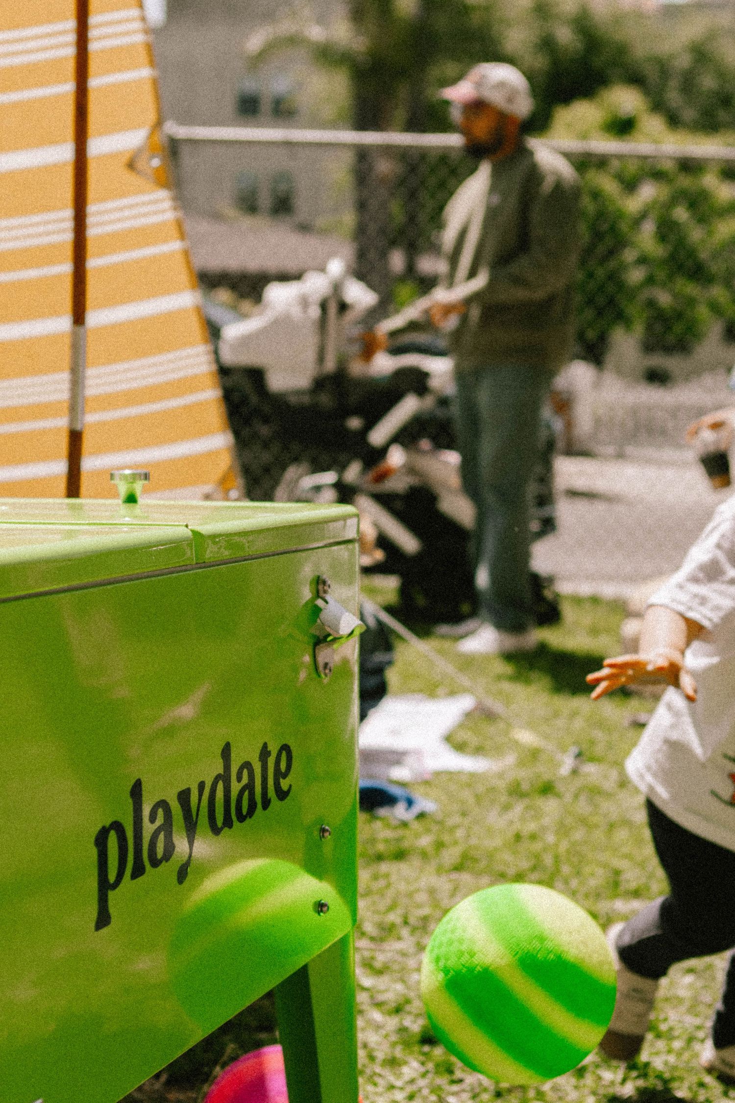 Green Playdate branded outdoor play equipment visible in a sunny garden setting.