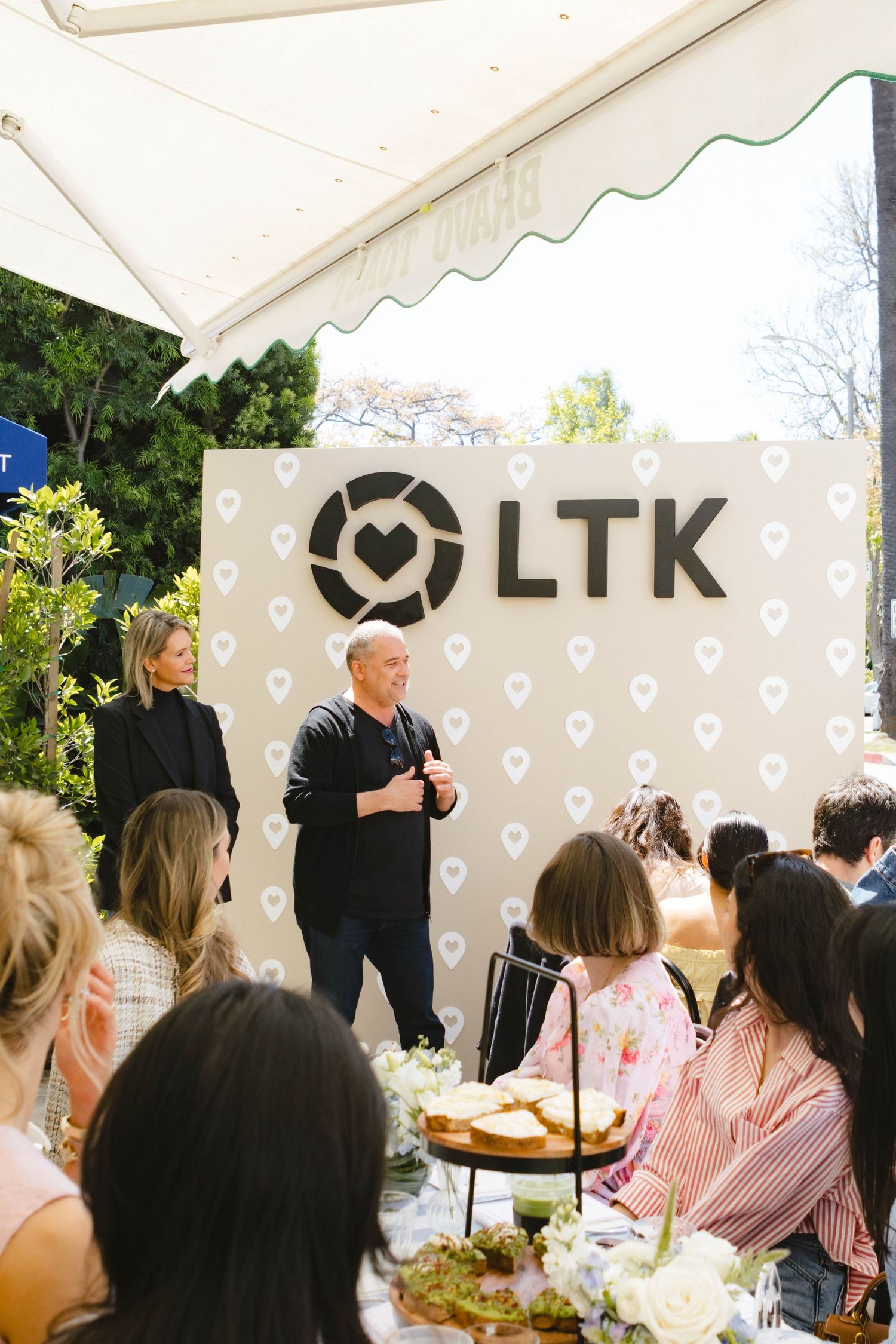 Outdoor event space with white tent and heart pattern decorations featuring LTK branding.
