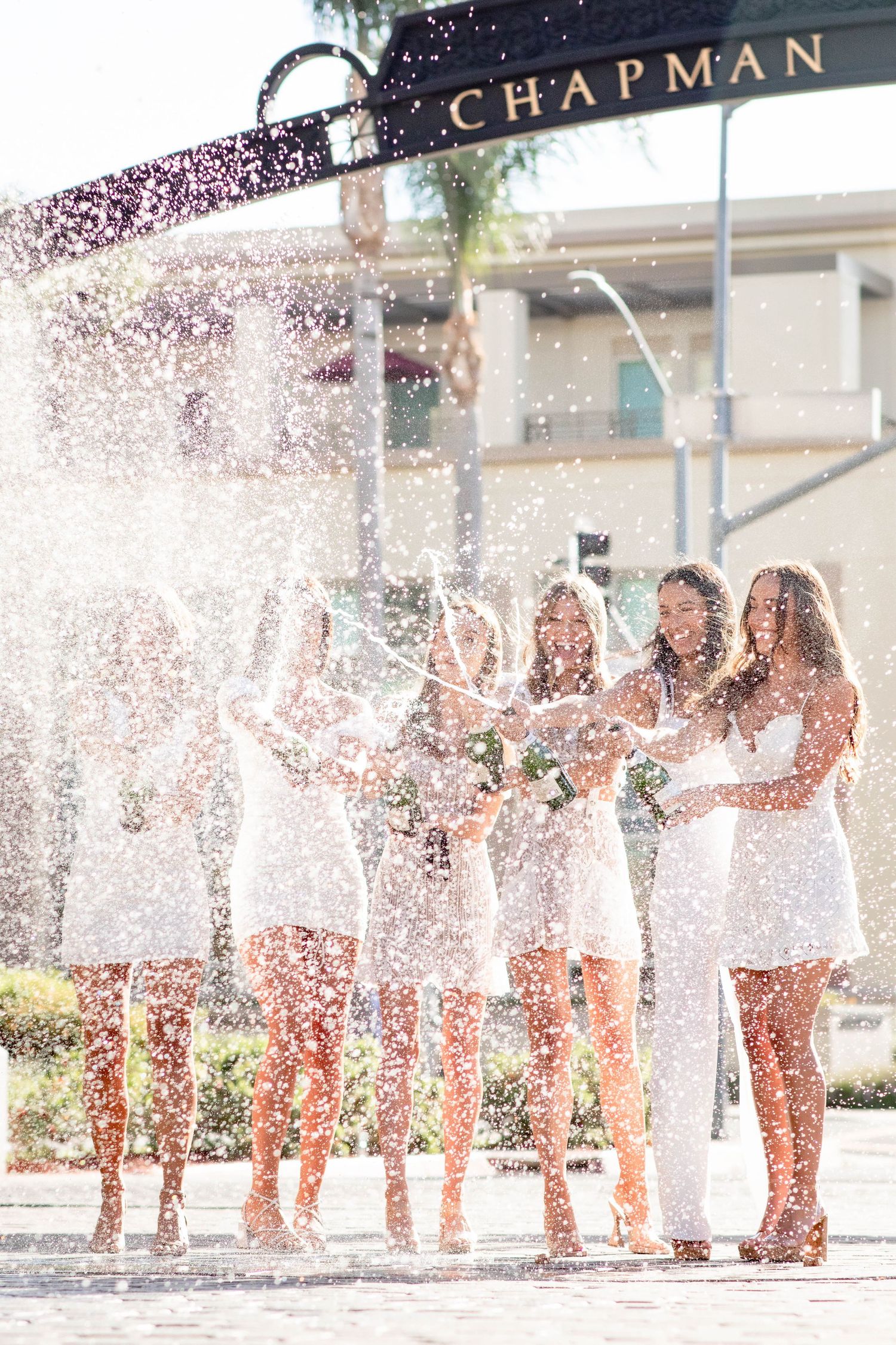 Group celebration with confetti at graduation ceremony.