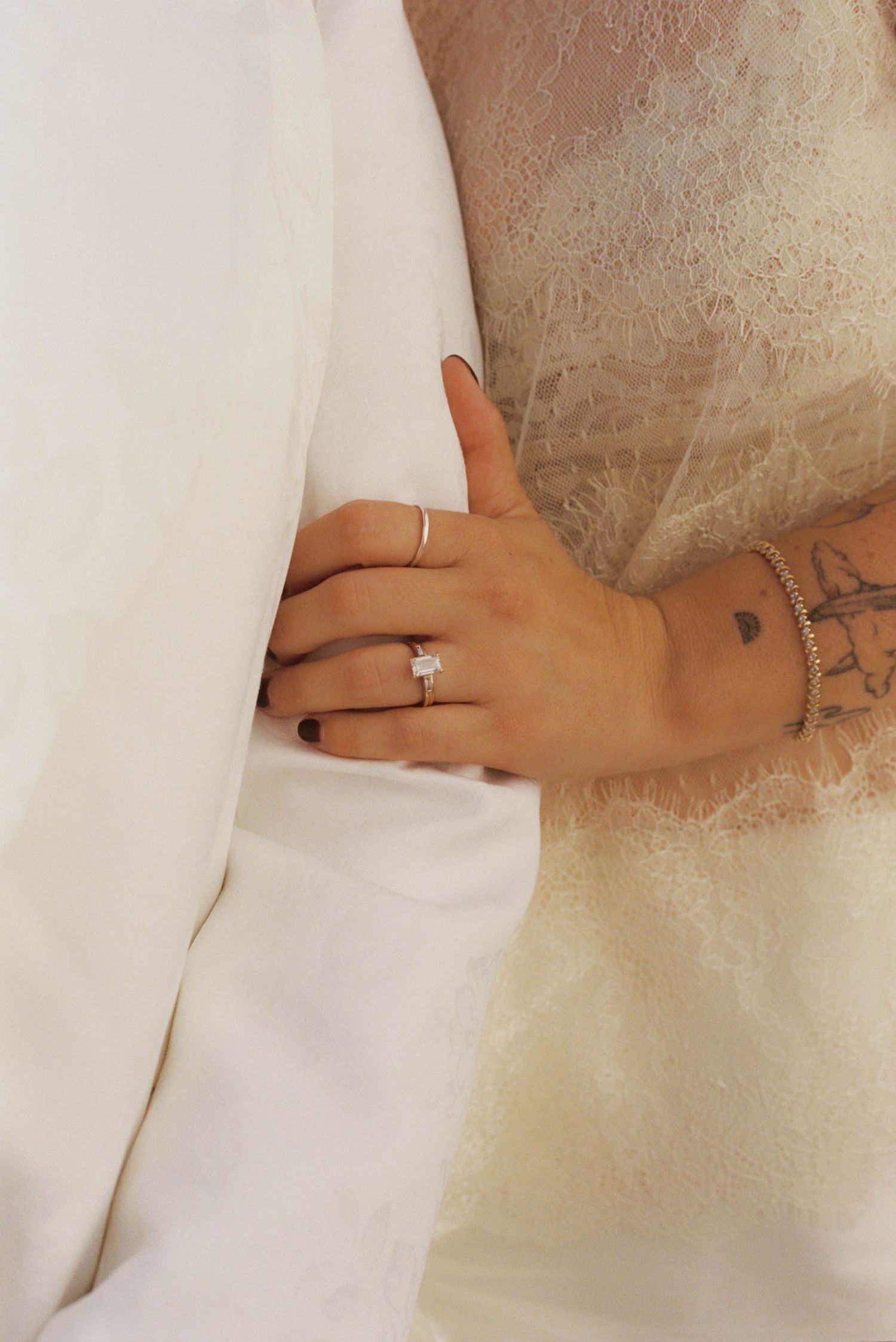 Close-up shots of hands with wedding rings against white fabric.