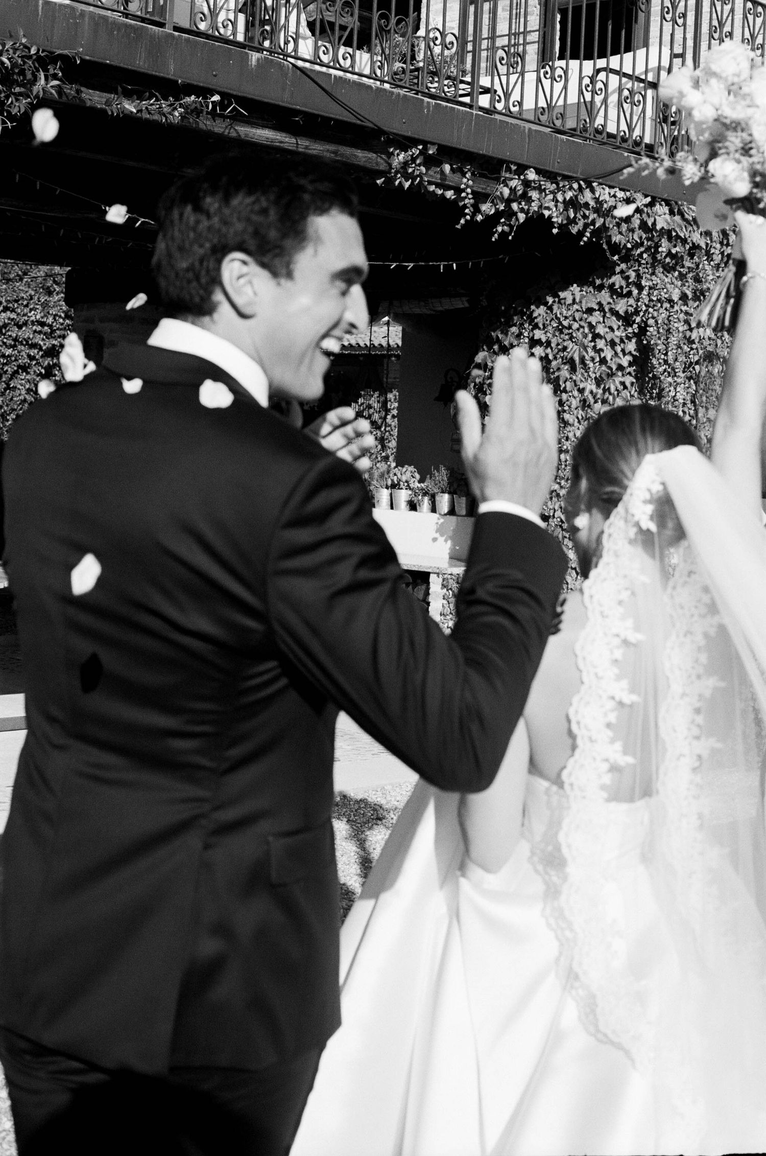 Wedding party members dance and celebrate in formal attire at an evening reception.