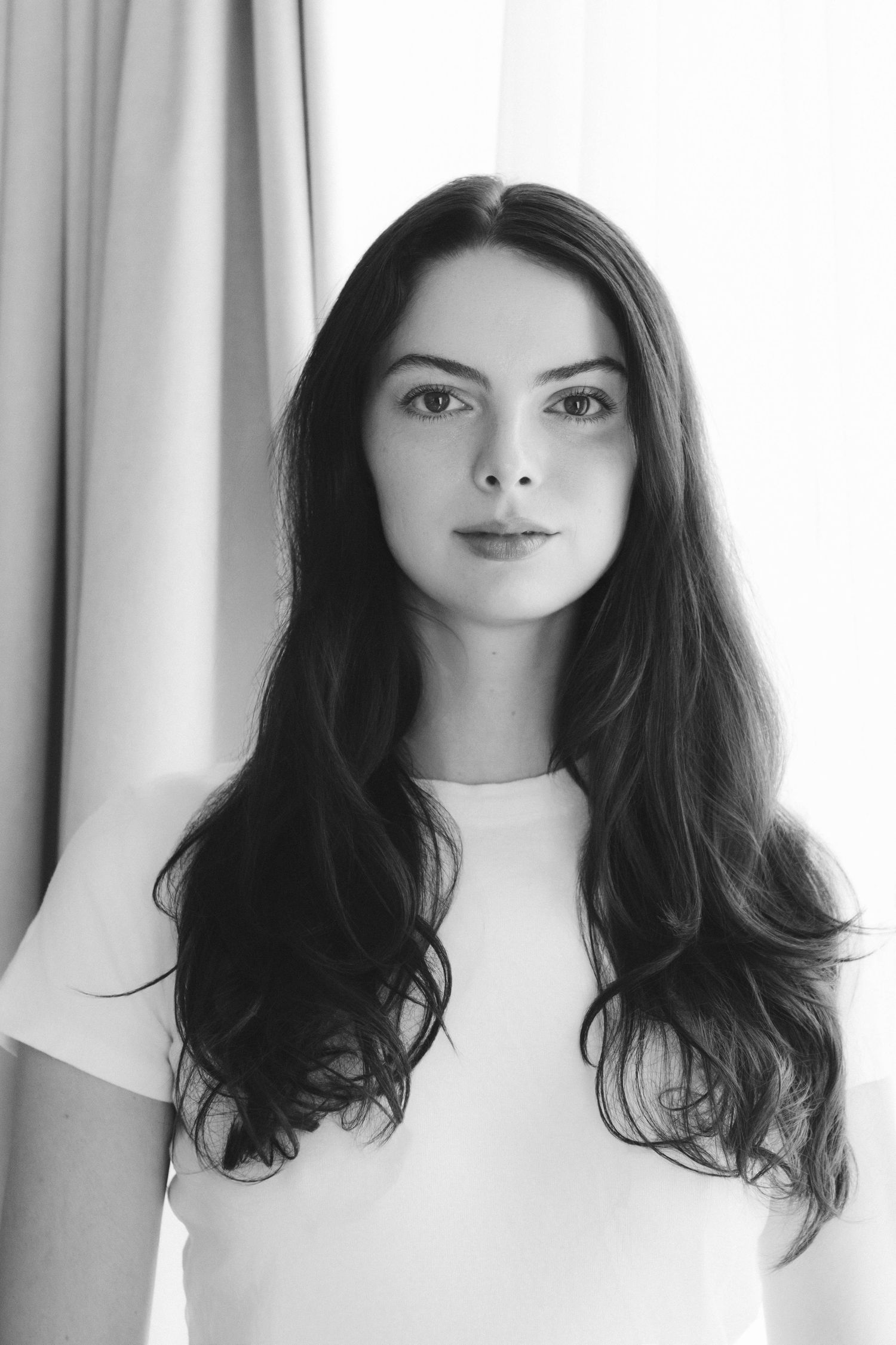 Portrait series showing different angles of a woman with dark hair against a white background.