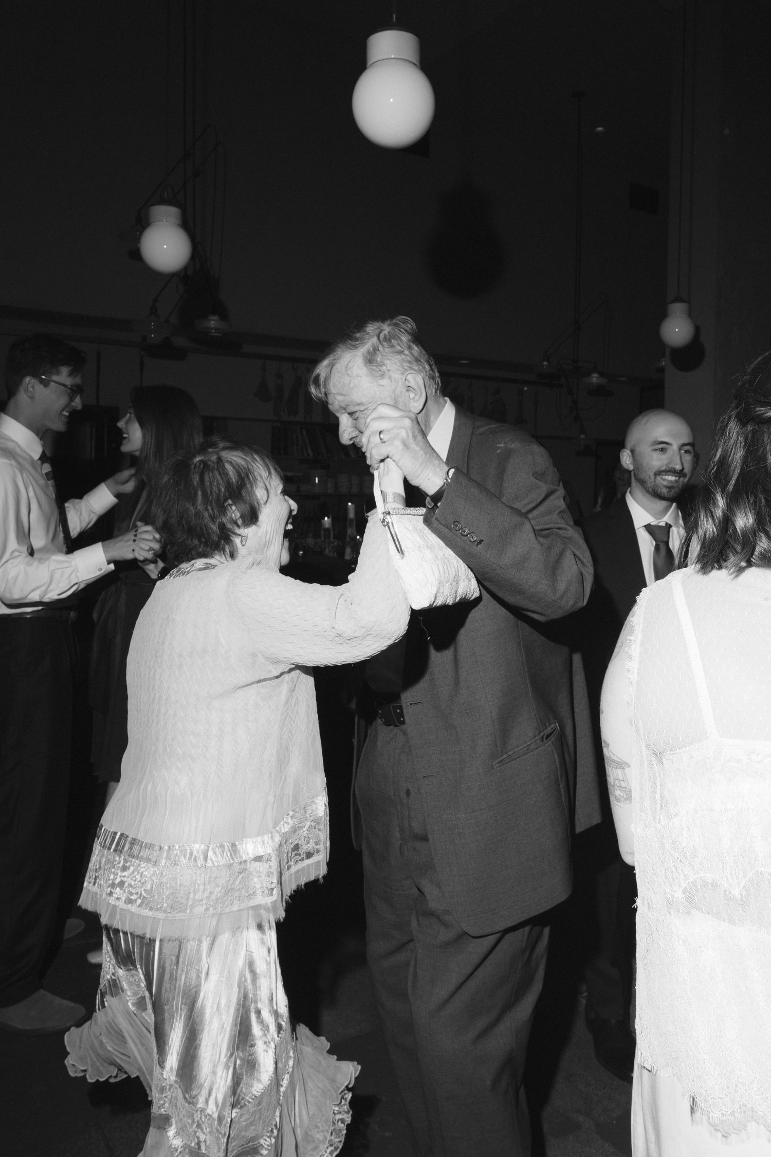 Couples dancing together at a formal event in black and white vintage photograph.