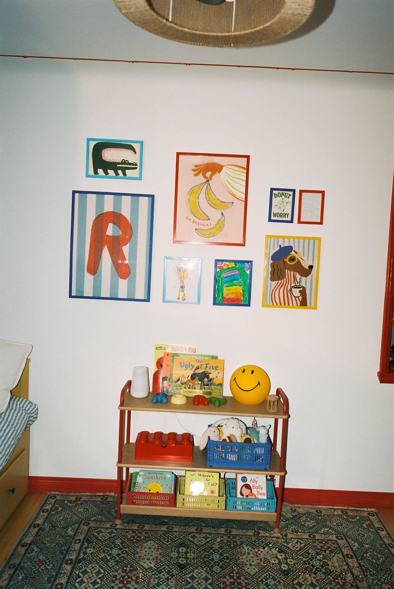 Children's room with colorful animal artwork and decorations on white walls.