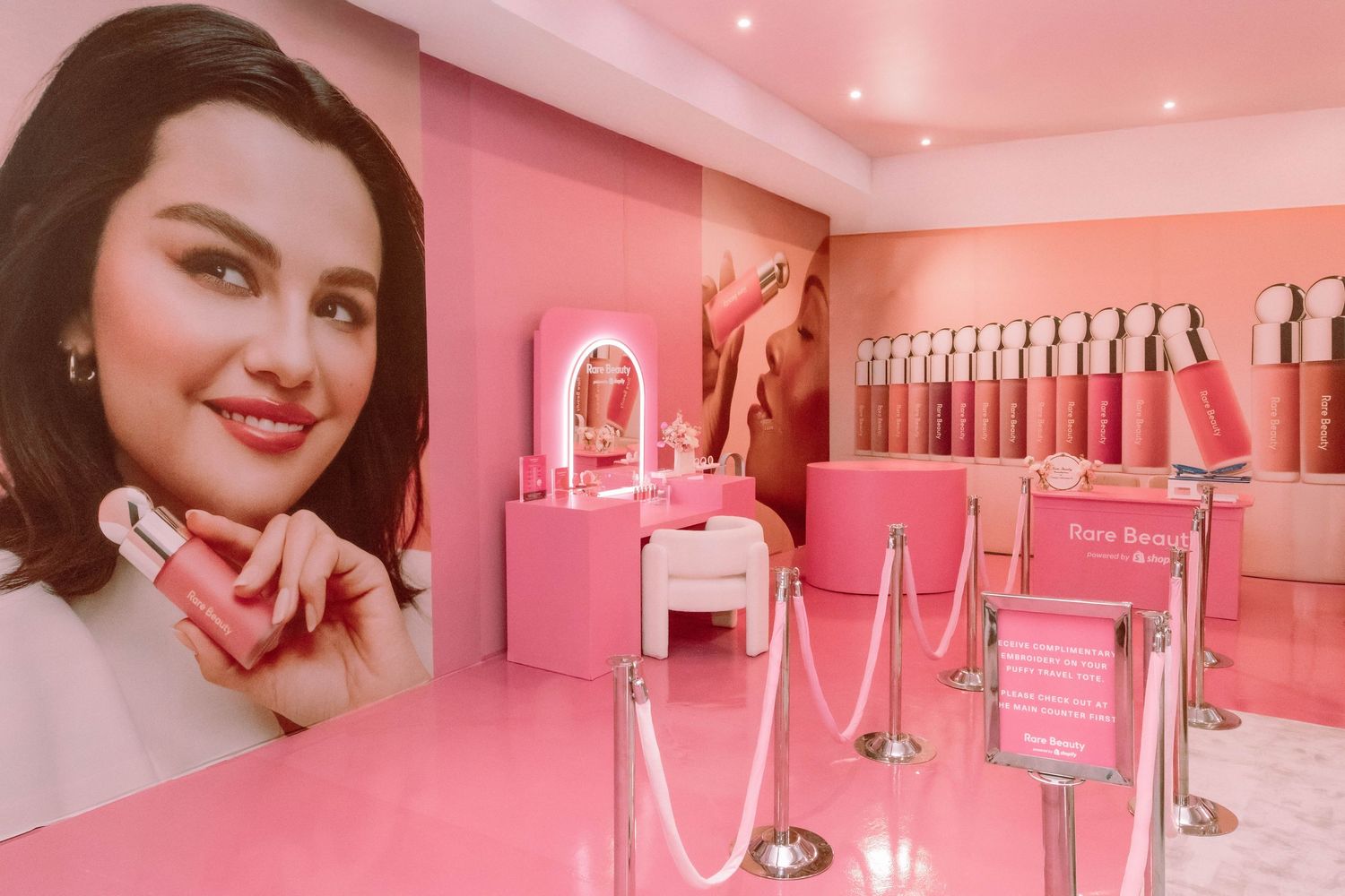 Pink-themed beauty salon interior with neon lighting and modern decor.