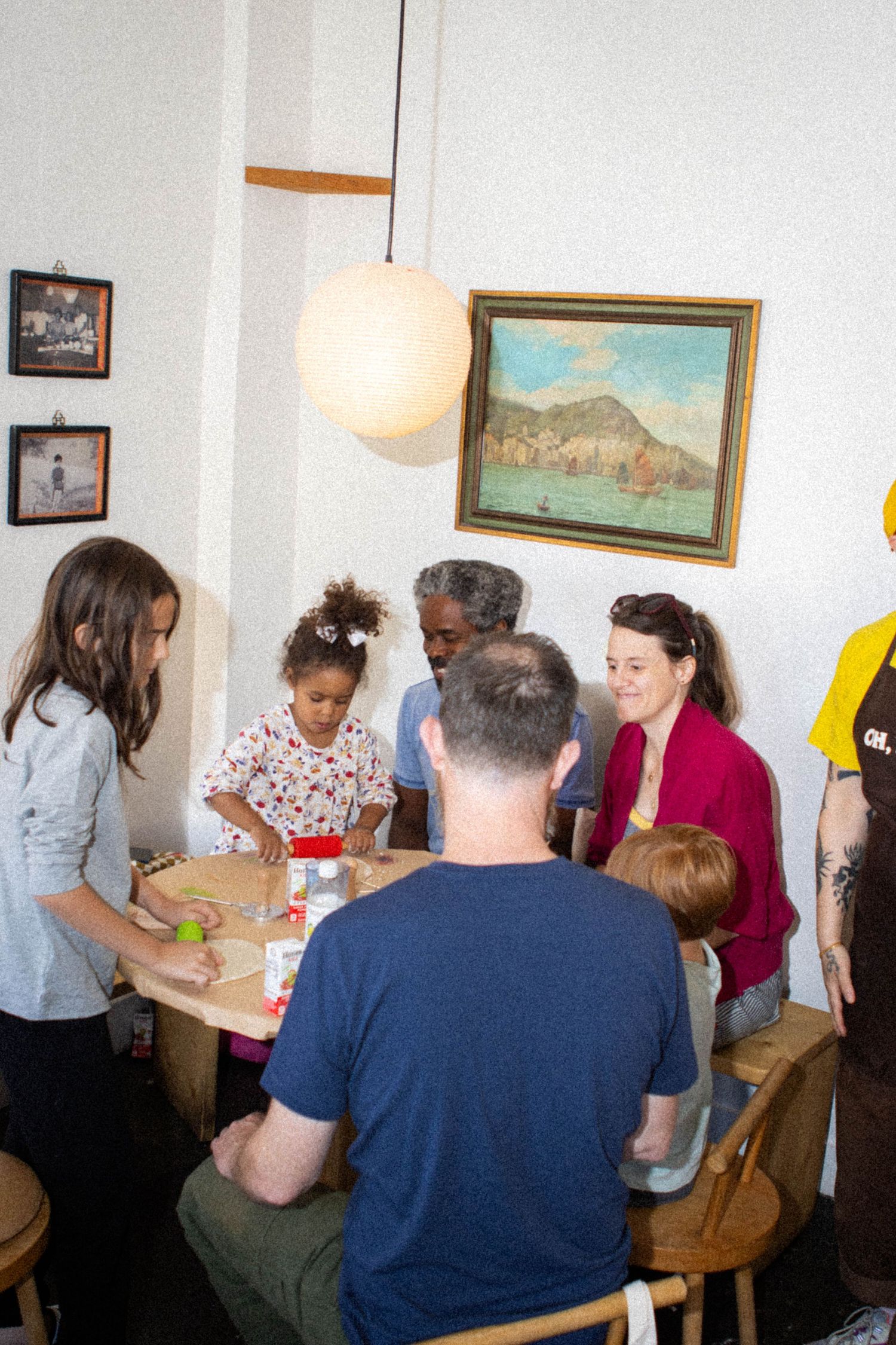 Group of people gathered around tables participating in a creative workshop or activity.
