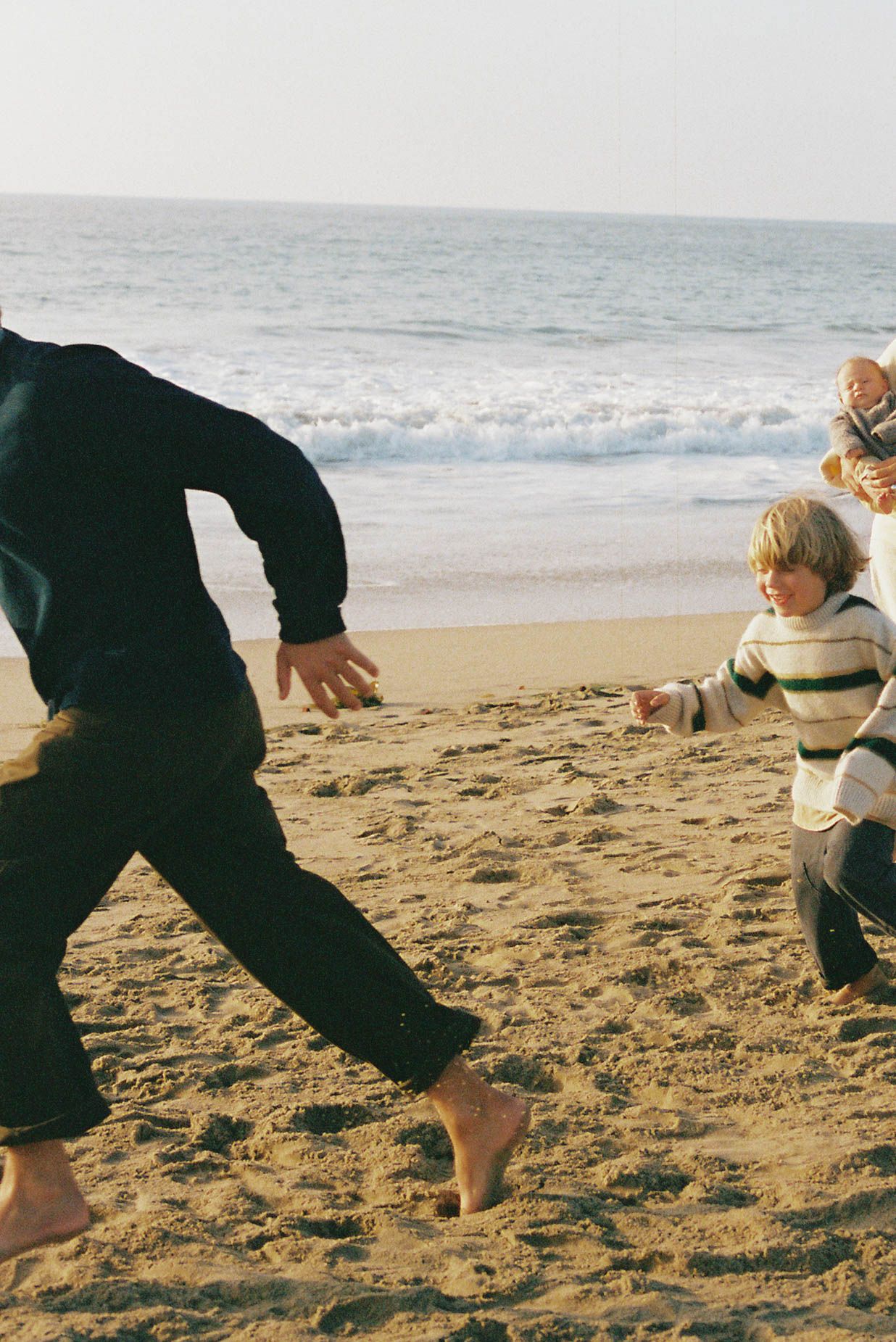 People playing and running on a sandy beach with ocean waves in the background, shown in a sequence of action shots.