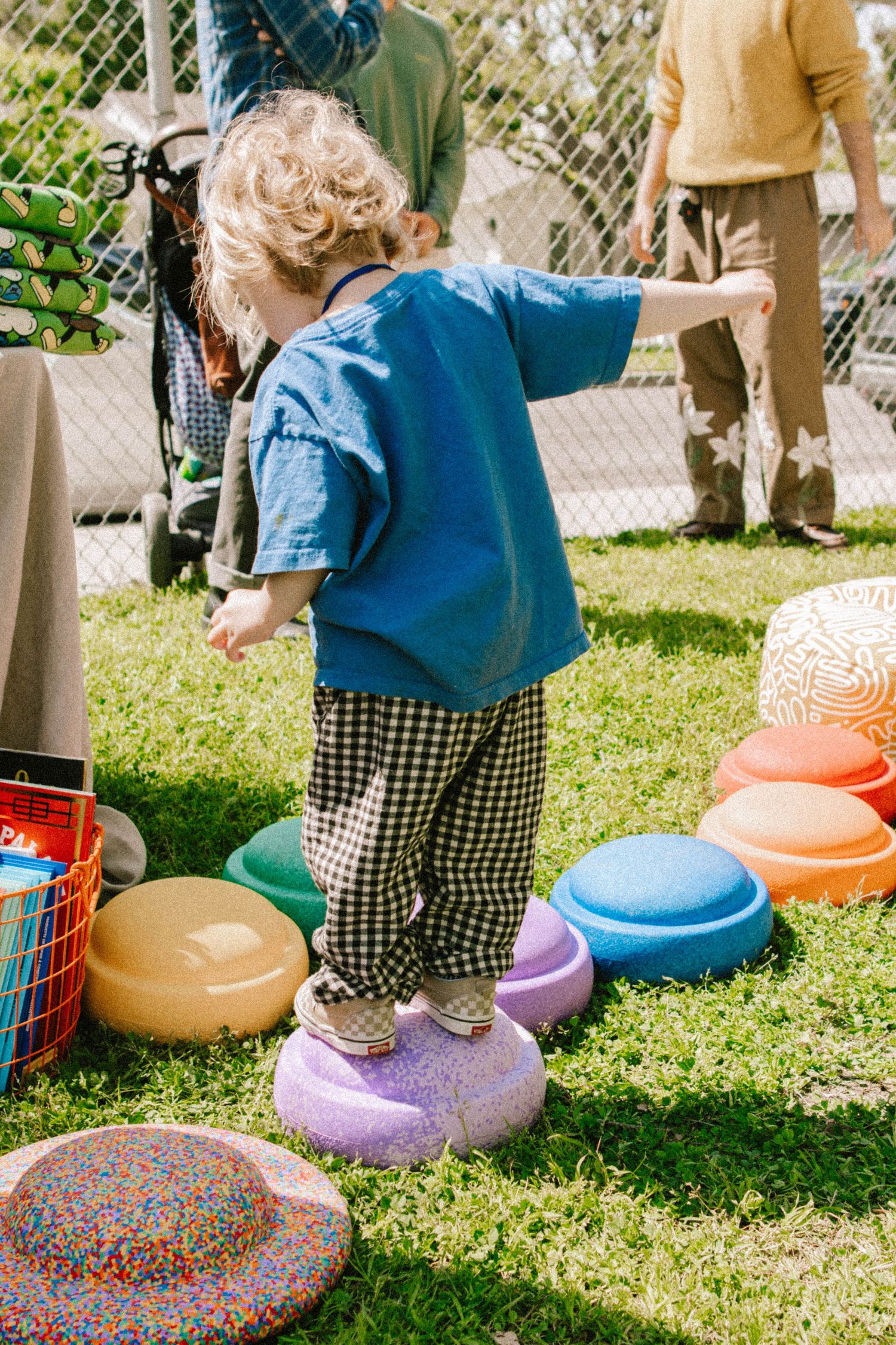 Colorful inflatable toys arranged on grass during an outdoor event.