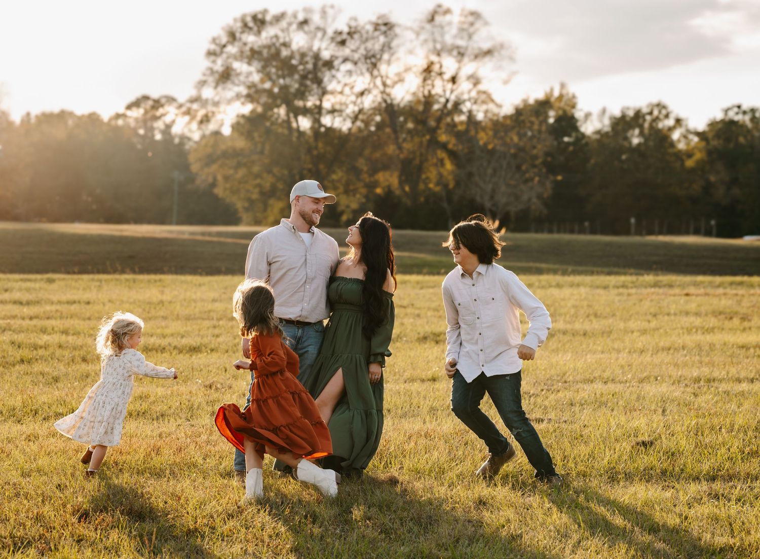 Children playing in a sun-drenched park during a lifestyle family session. Candid family portraits in Perry, Georgia by C + F Photography.