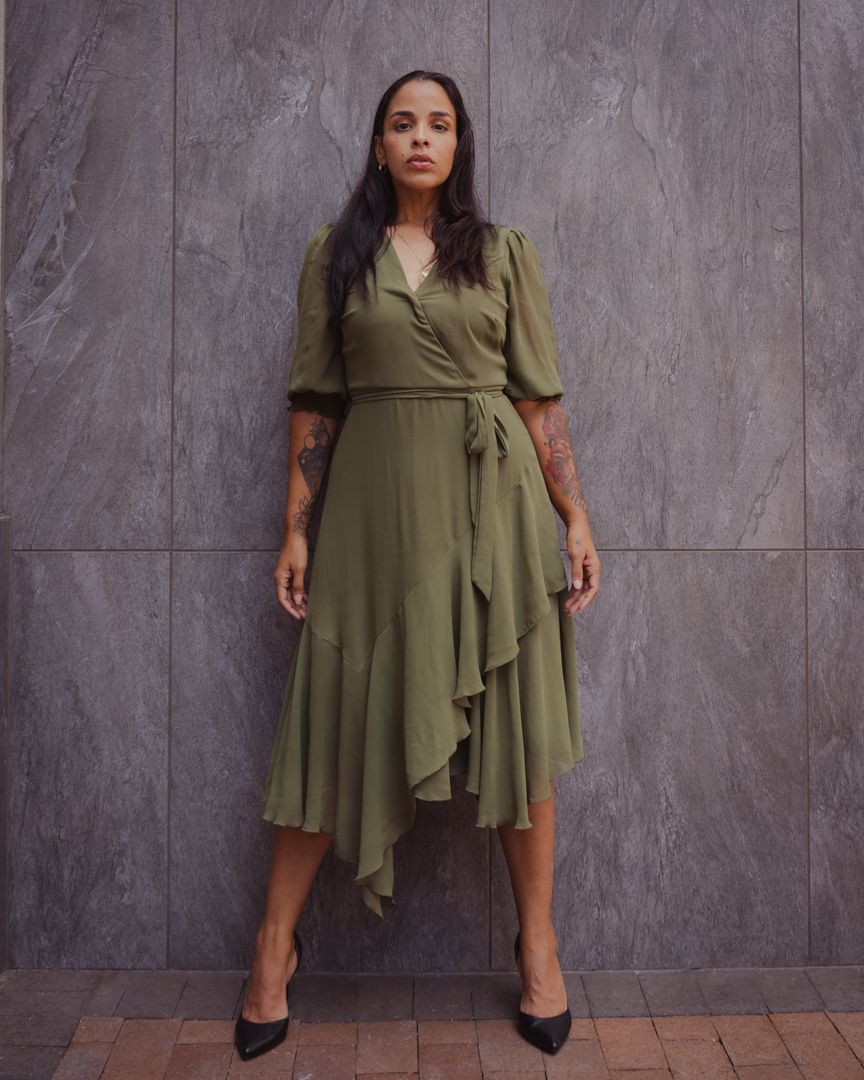 Olive green wrap dress with short sleeves and asymmetrical ruffle detail shown from multiple angles on grey background.