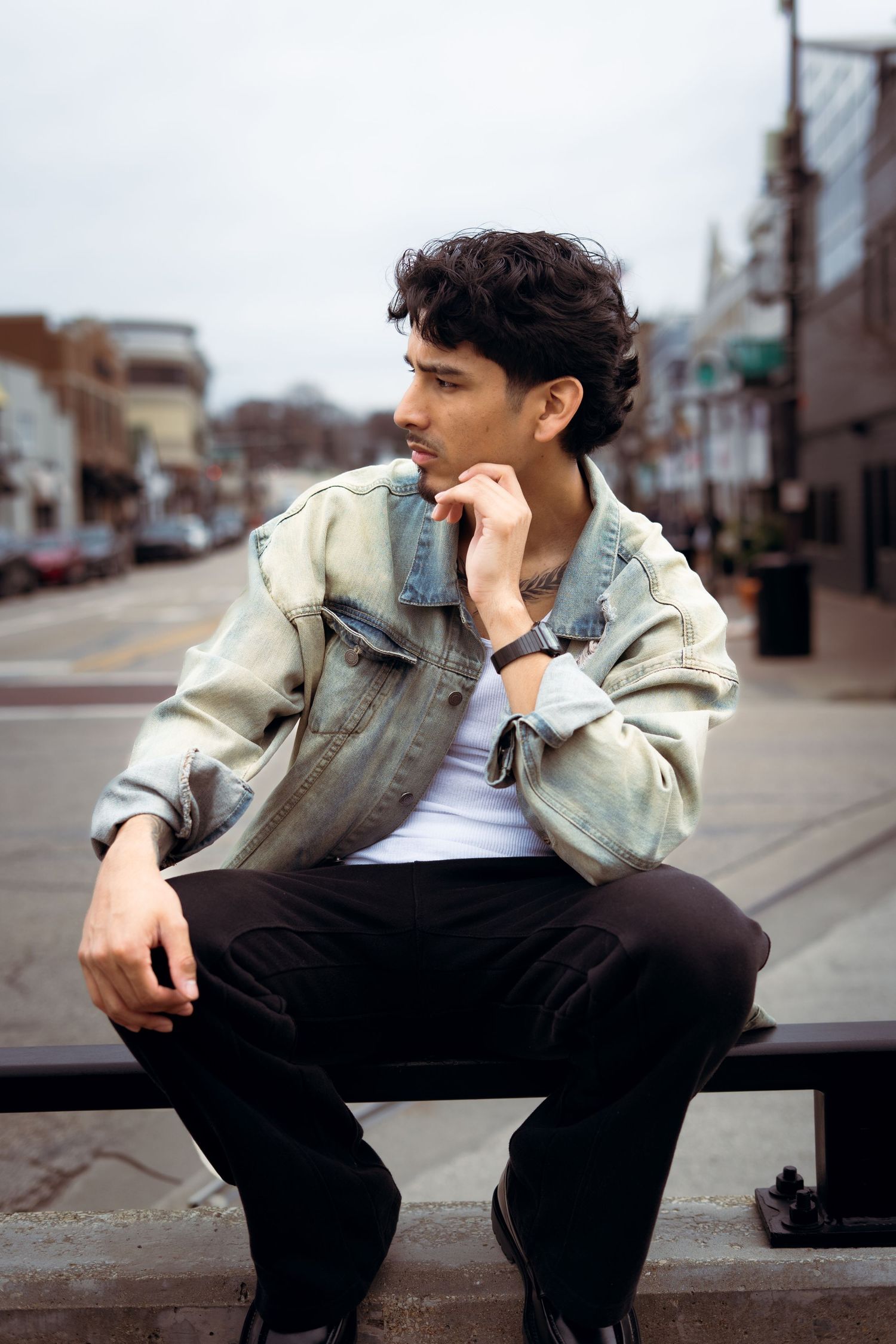 A person in a light jacket and dark pants sits thoughtfully on urban steps in a series of similar poses.