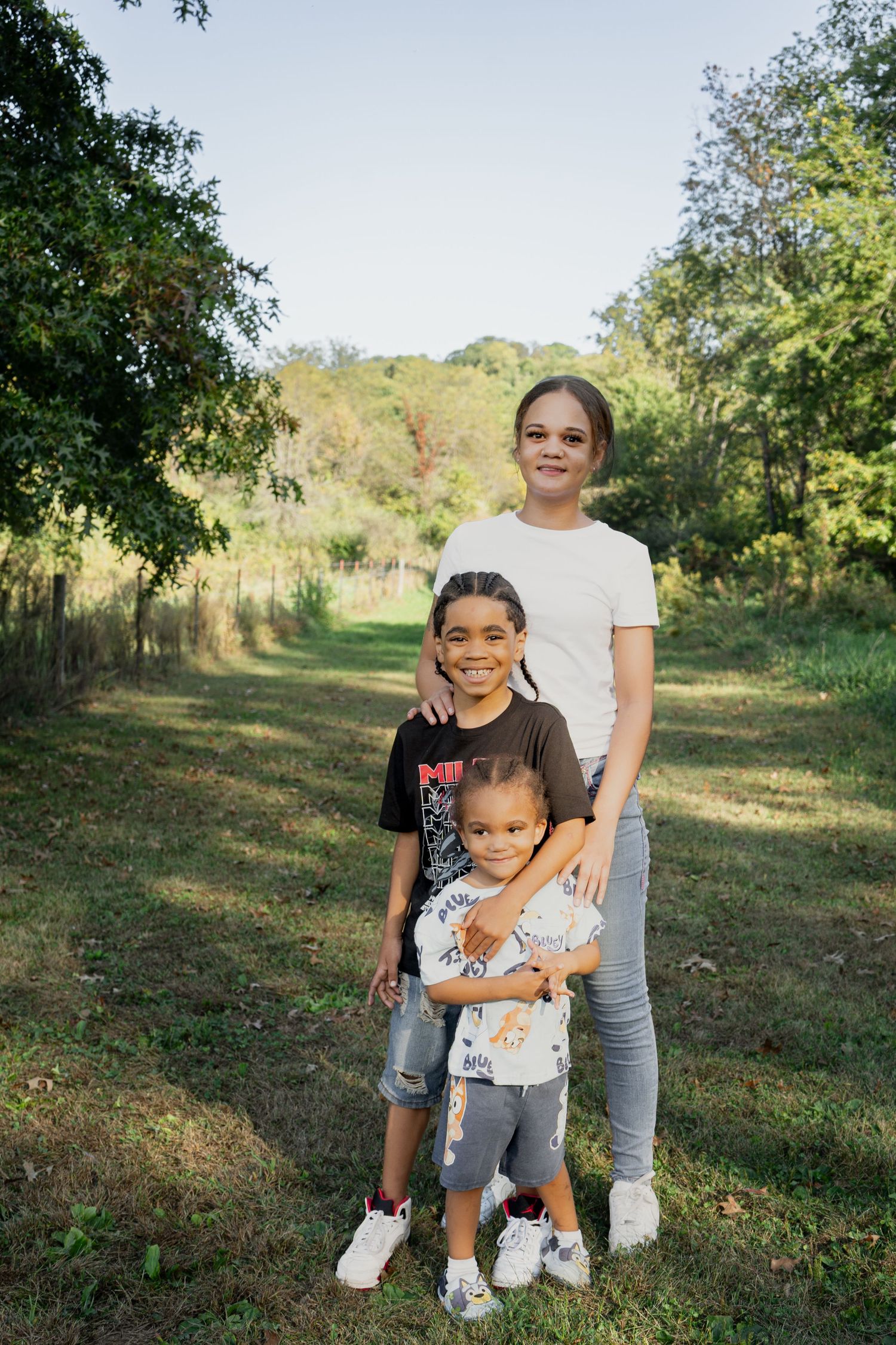 A collection of casual outdoor portraits taken in a grassy field with trees in the background.