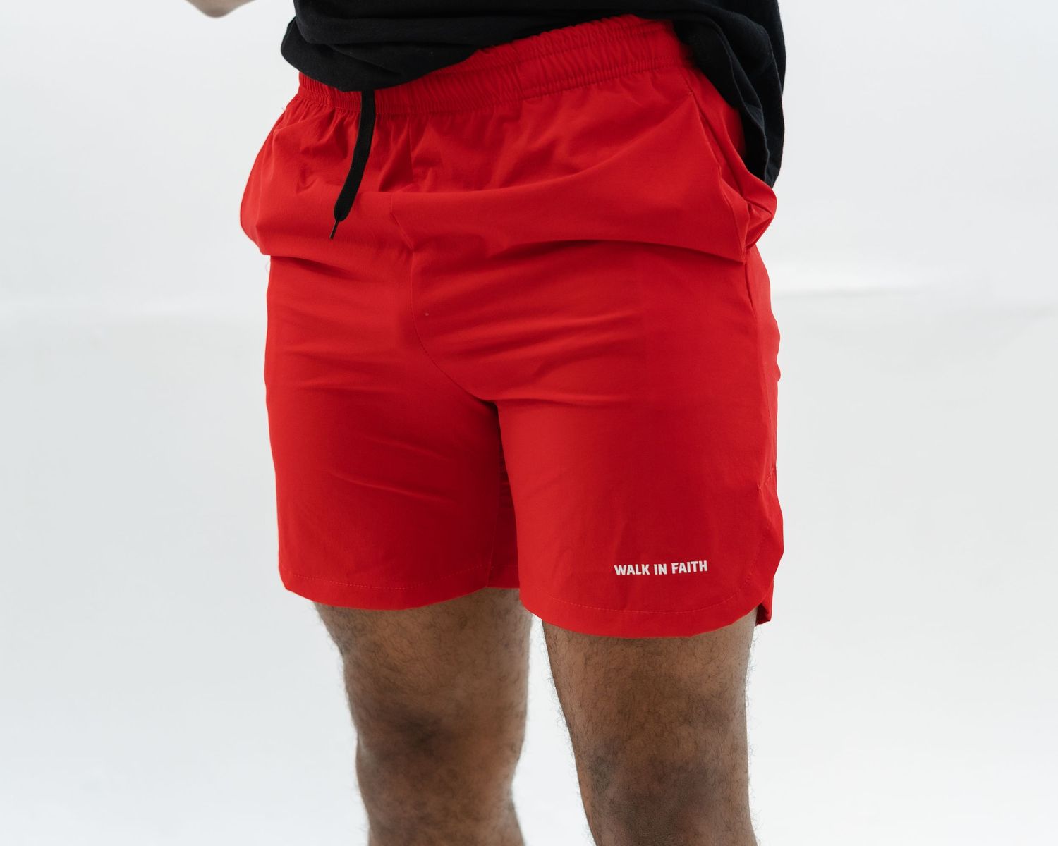 Red swim shorts with white drawstring and logo detail shown from multiple angles against white background.