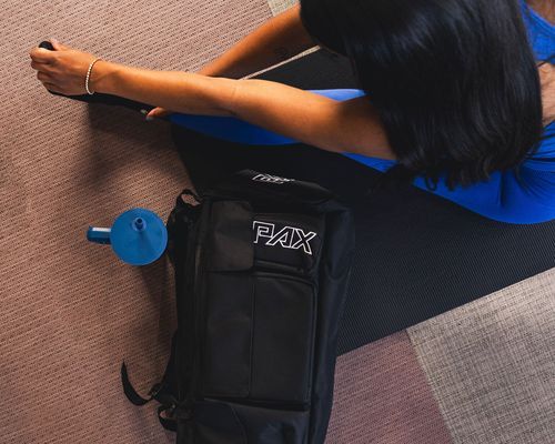 Close-up of black gym bag against textured background.