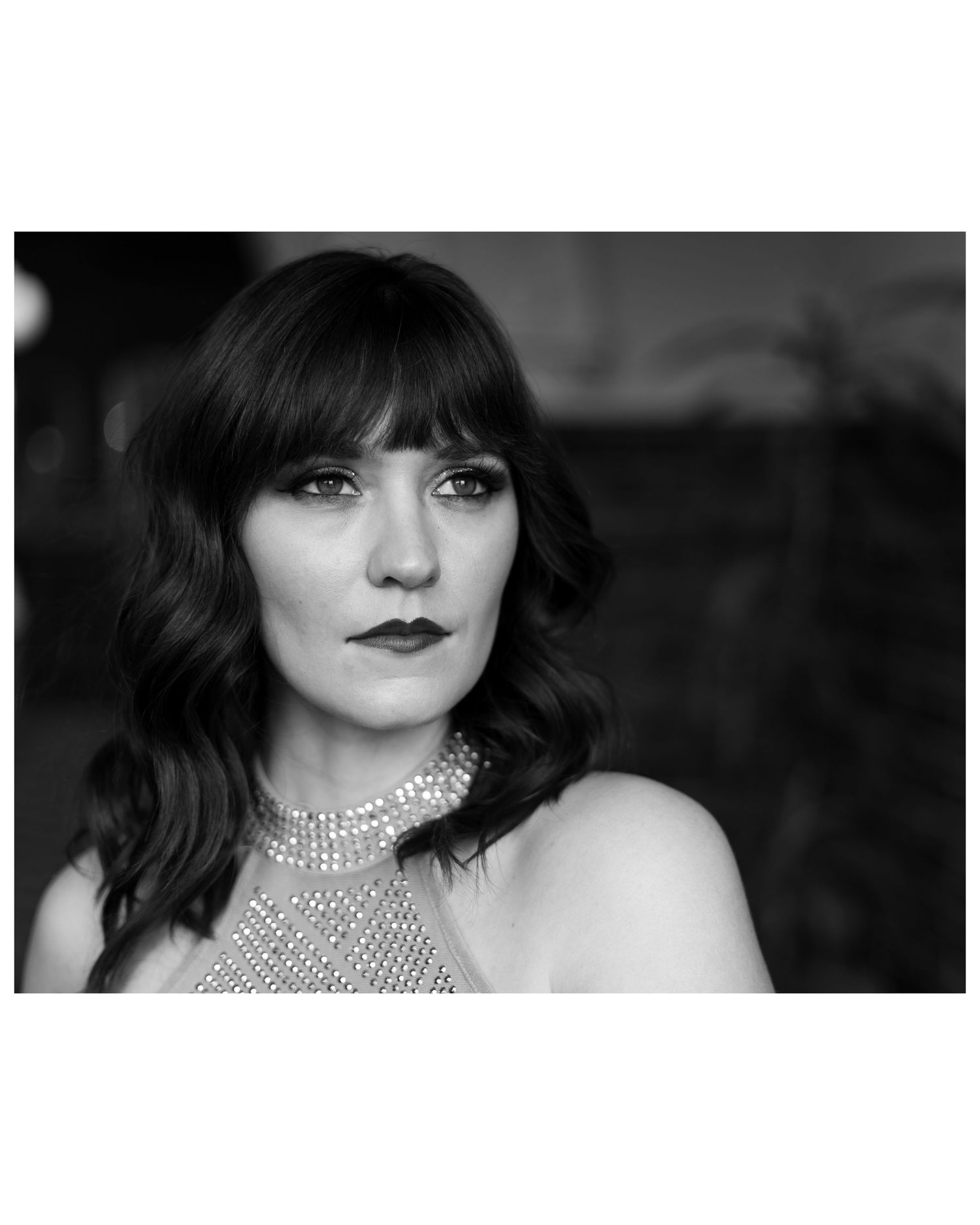 Black and white glamour editorial portraits featuring sparkly high-neck collar and dramatic lighting.