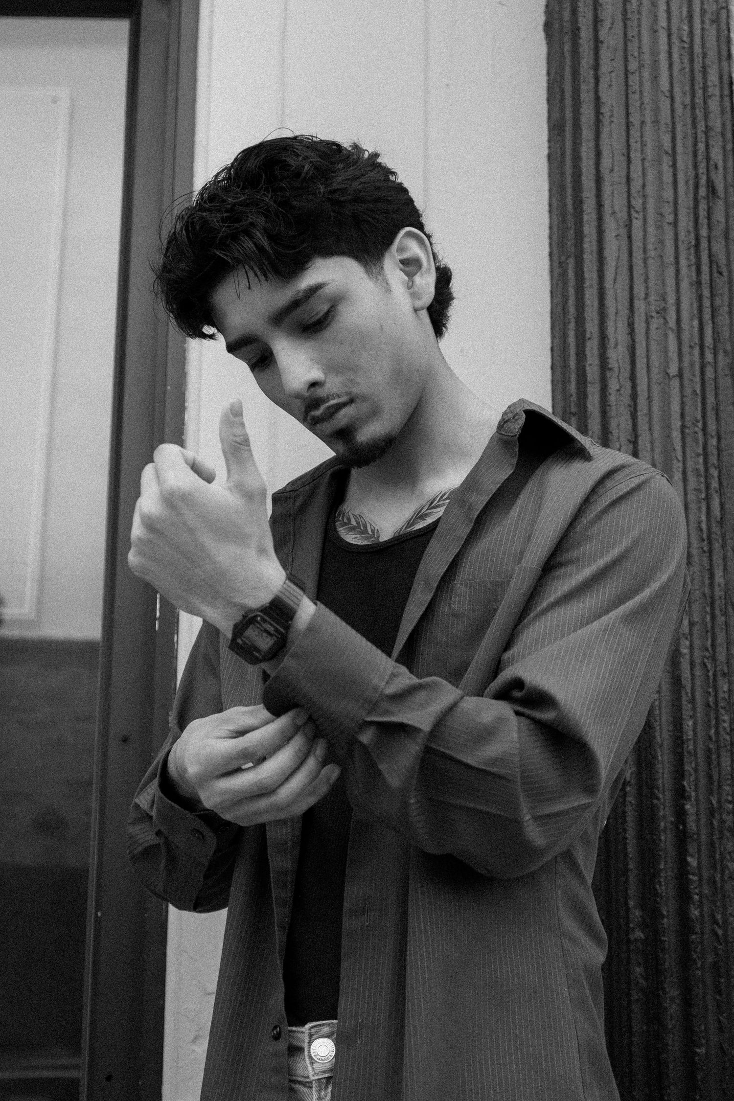 Black and white editorial portrait showing dramatic poses in formal attire.