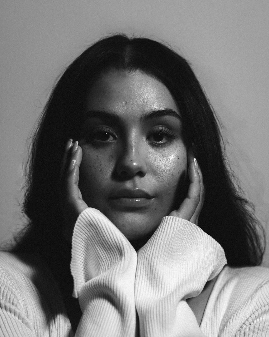 Black and white editorial portrait series showing person with turtleneck sweater in dramatic lighting.