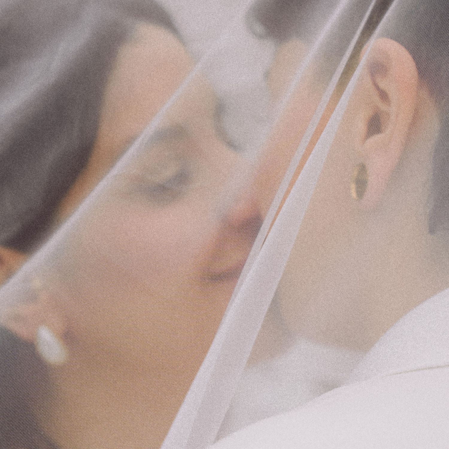 Lesbian couple kissing softly under a veil in a film-inspired style; San Francisco Bay Area; Mandarin, Cantonese, English.
