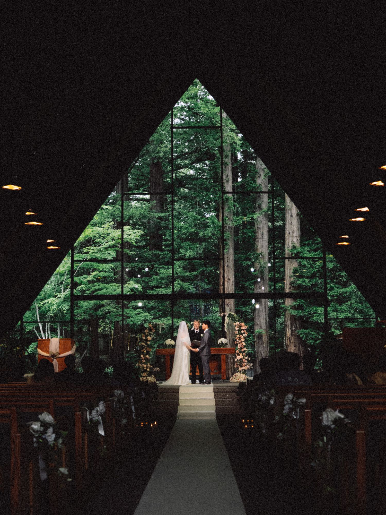 Asian couple at the altar in a forest chapel in the San Francisco Bay Area; natural, film-inspired style; Mandarin, Cantonese, English.