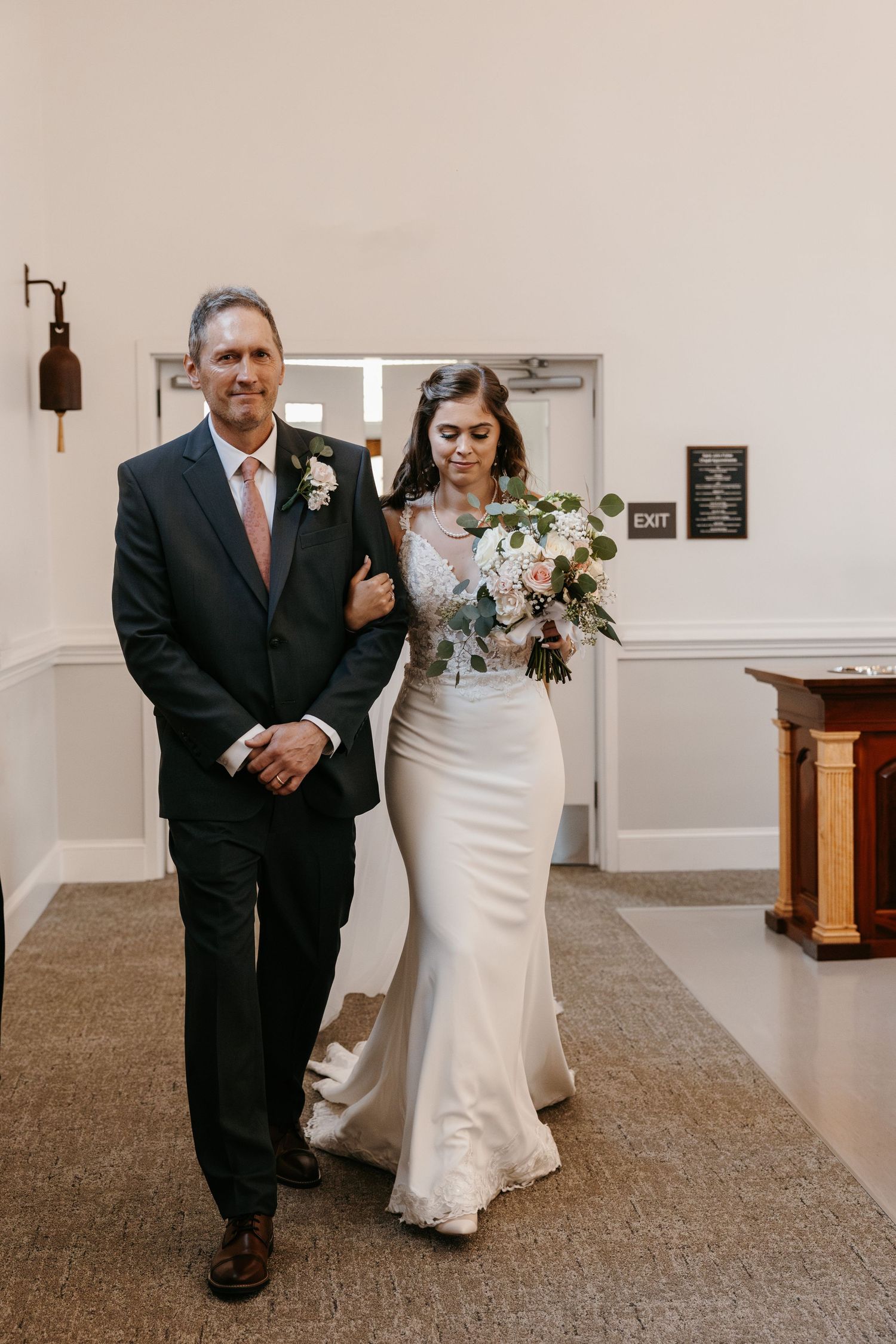 Wedding ceremony processional in a bright church interior.