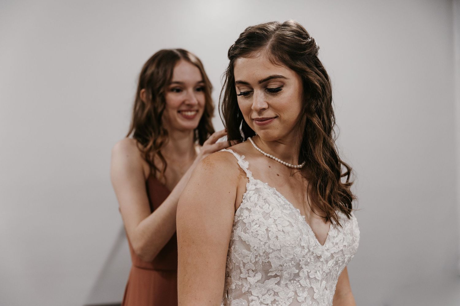 Candid getting ready moments with bride and a bridesmaid.