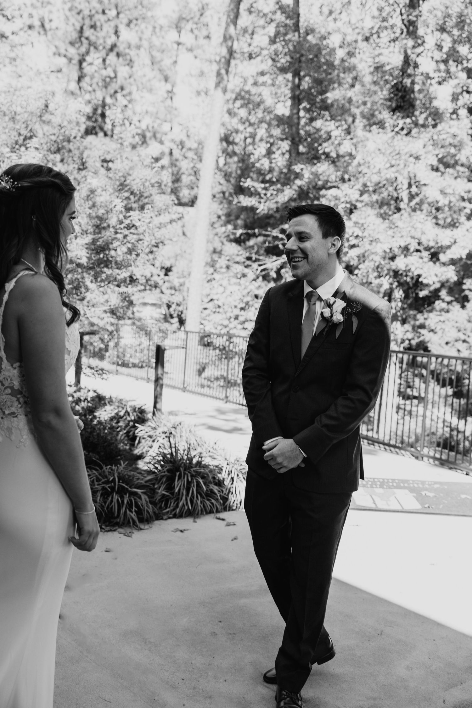 Black and white photo of couple's first look moment on outdoor patio.