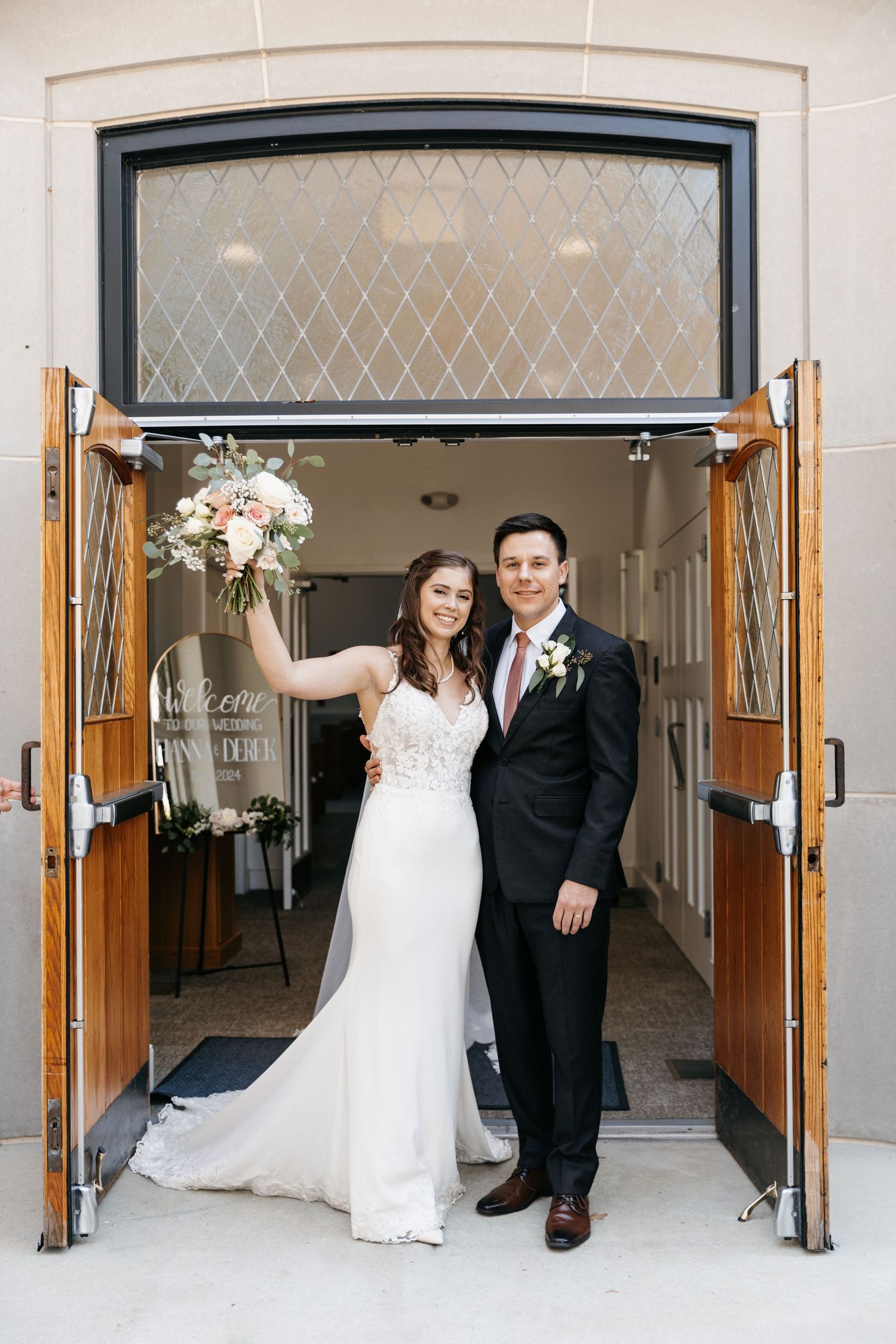 Wedding photo series in an elegant building entrance with arched doorways.