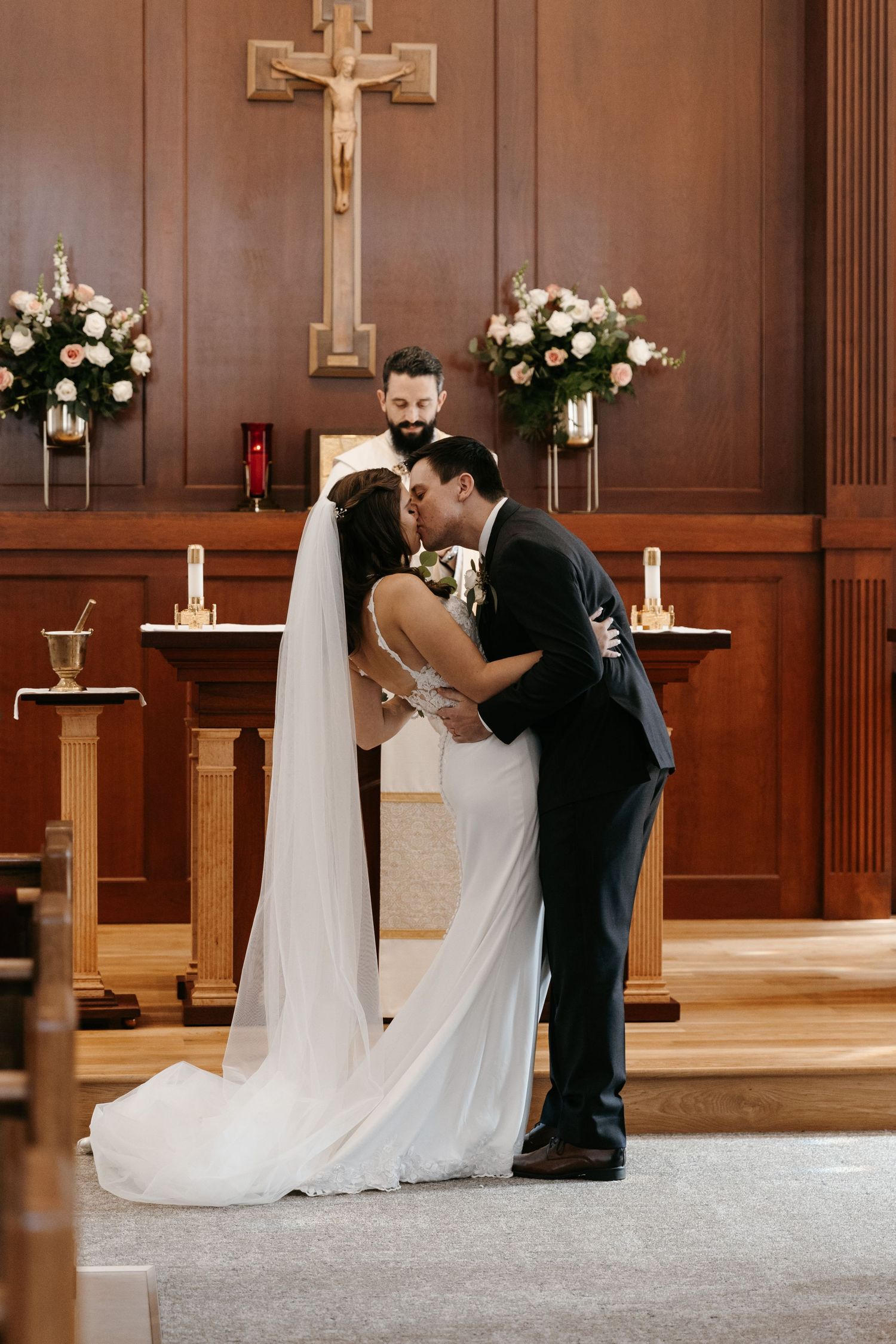 Couple shares first kiss in a church.