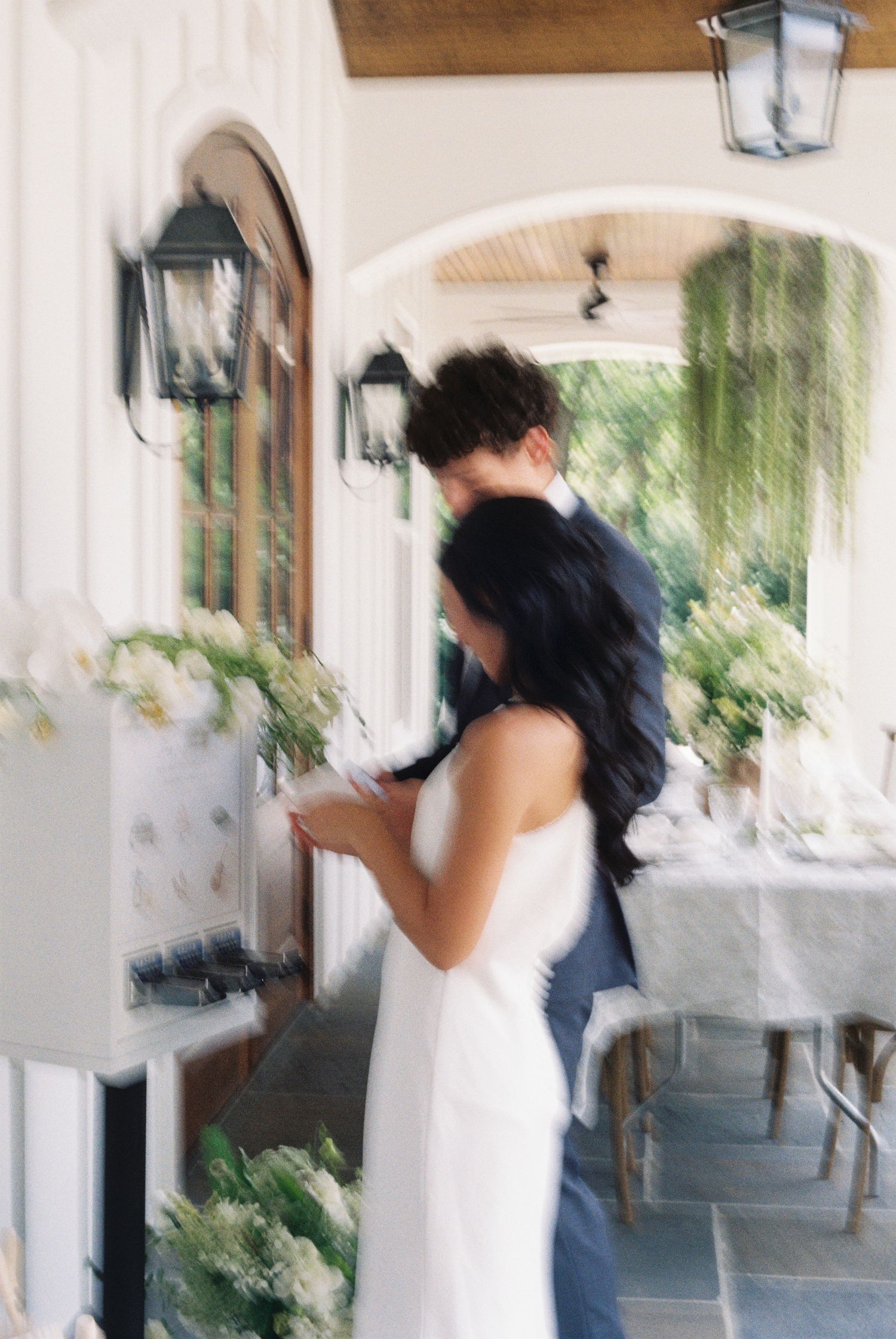 Motion blur sequence of a couple using a custom sticker vending machine on their wedding day.