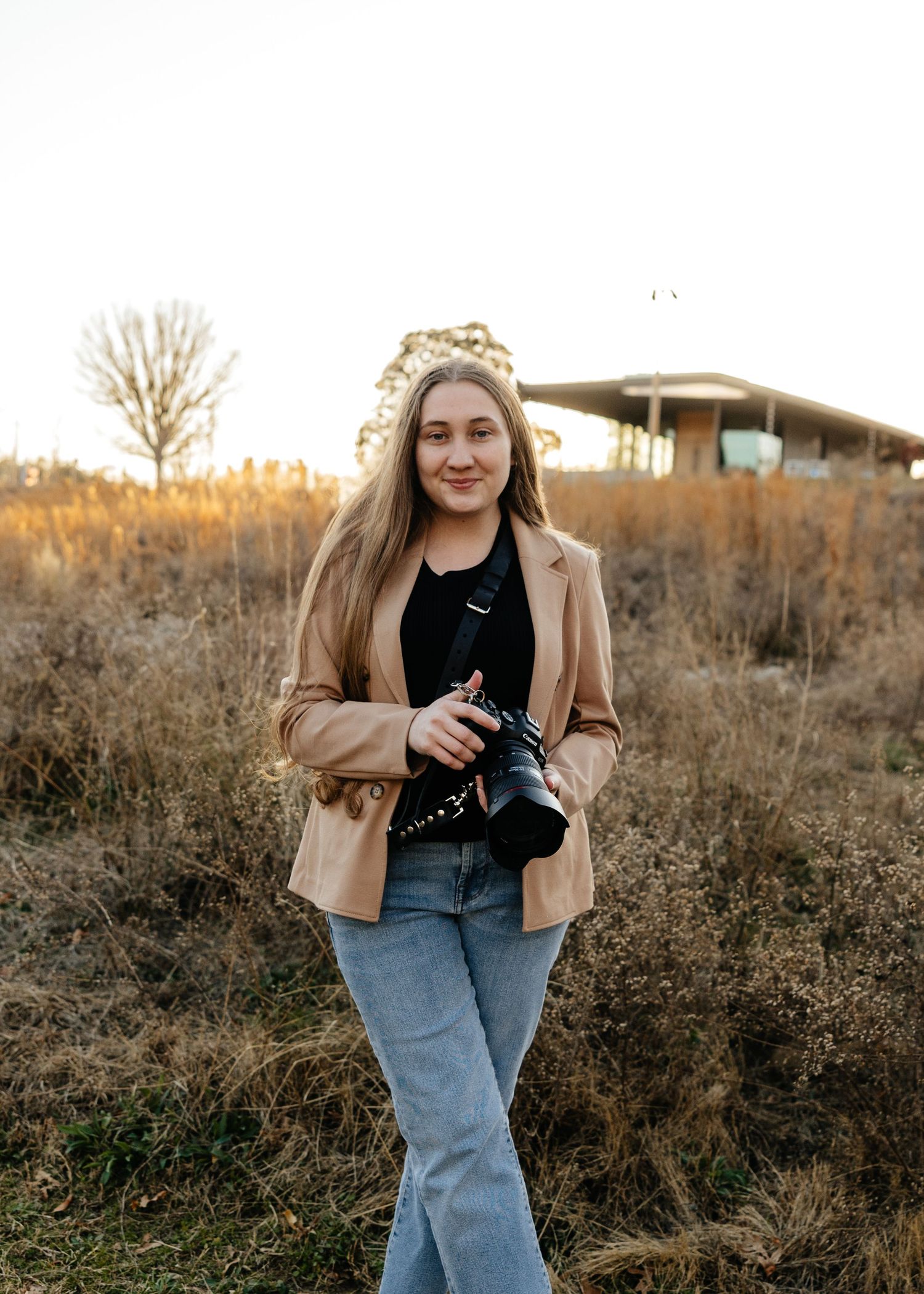 Casual outdoor headshot portrait gf photographer taken in a natural setting during golden hour.