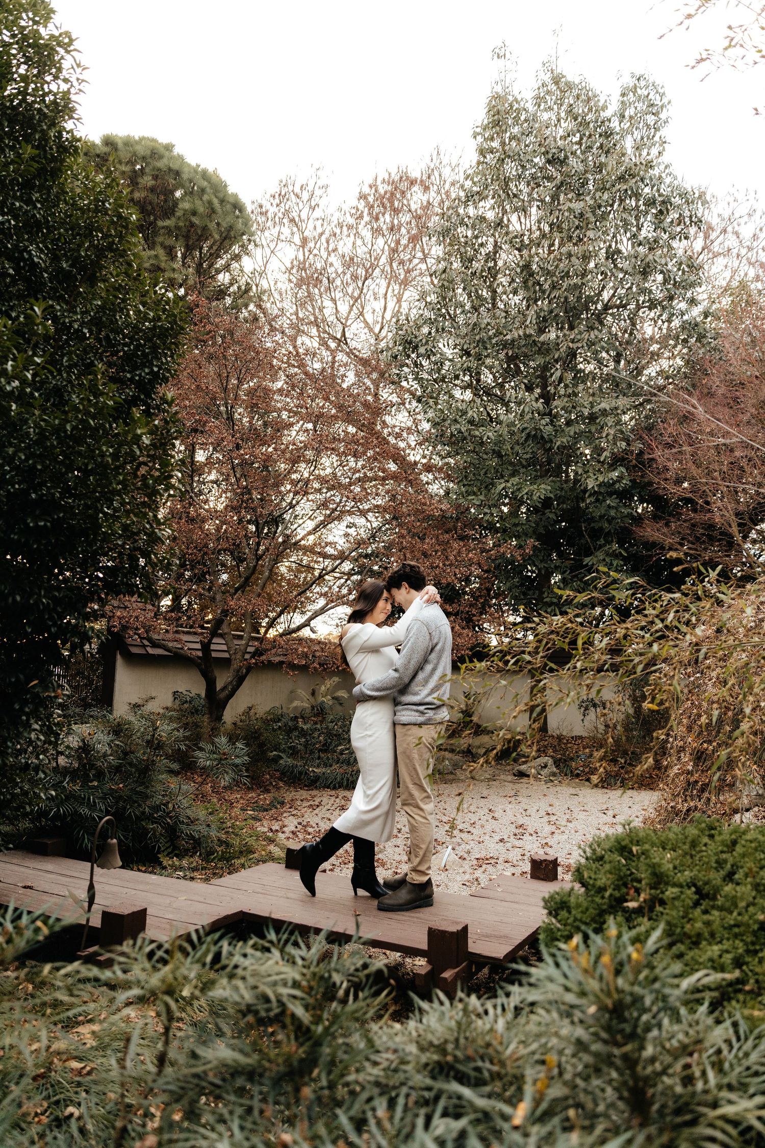 Romantic outdoor engagement photoshoot among fall foliage.
