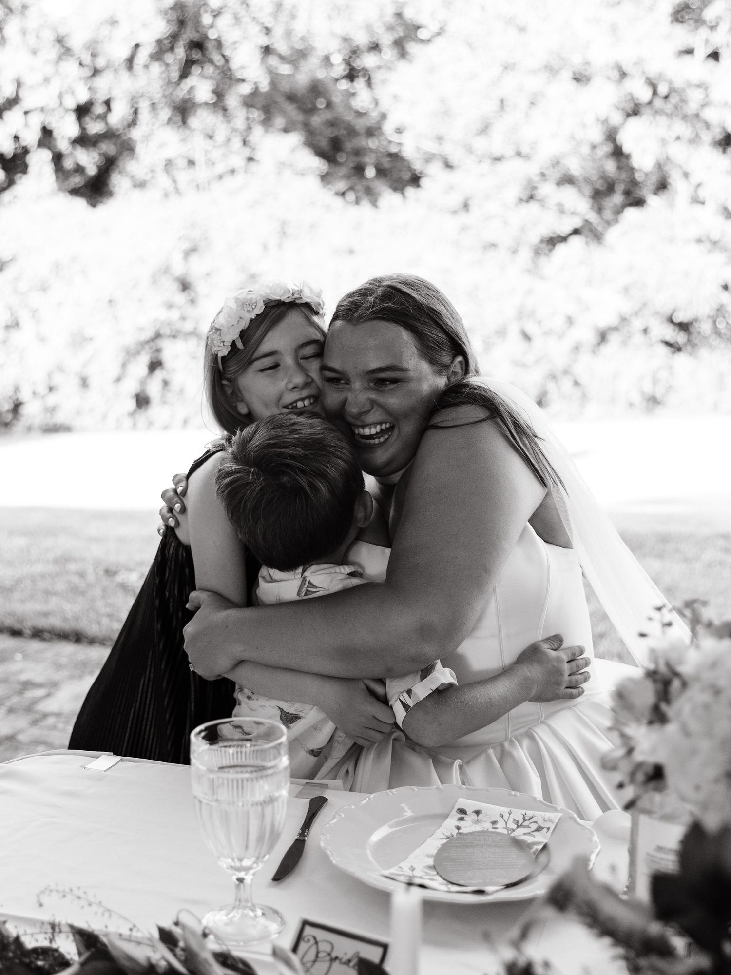 Black and white candid moments of celebration and laughter at a wedding reception.