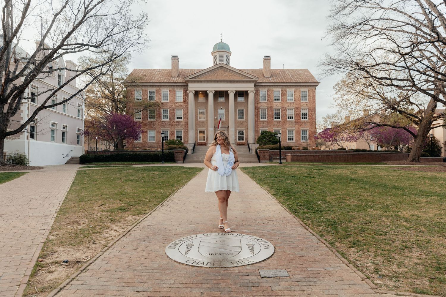 Historic brick building with classical architecture and a central walkway.