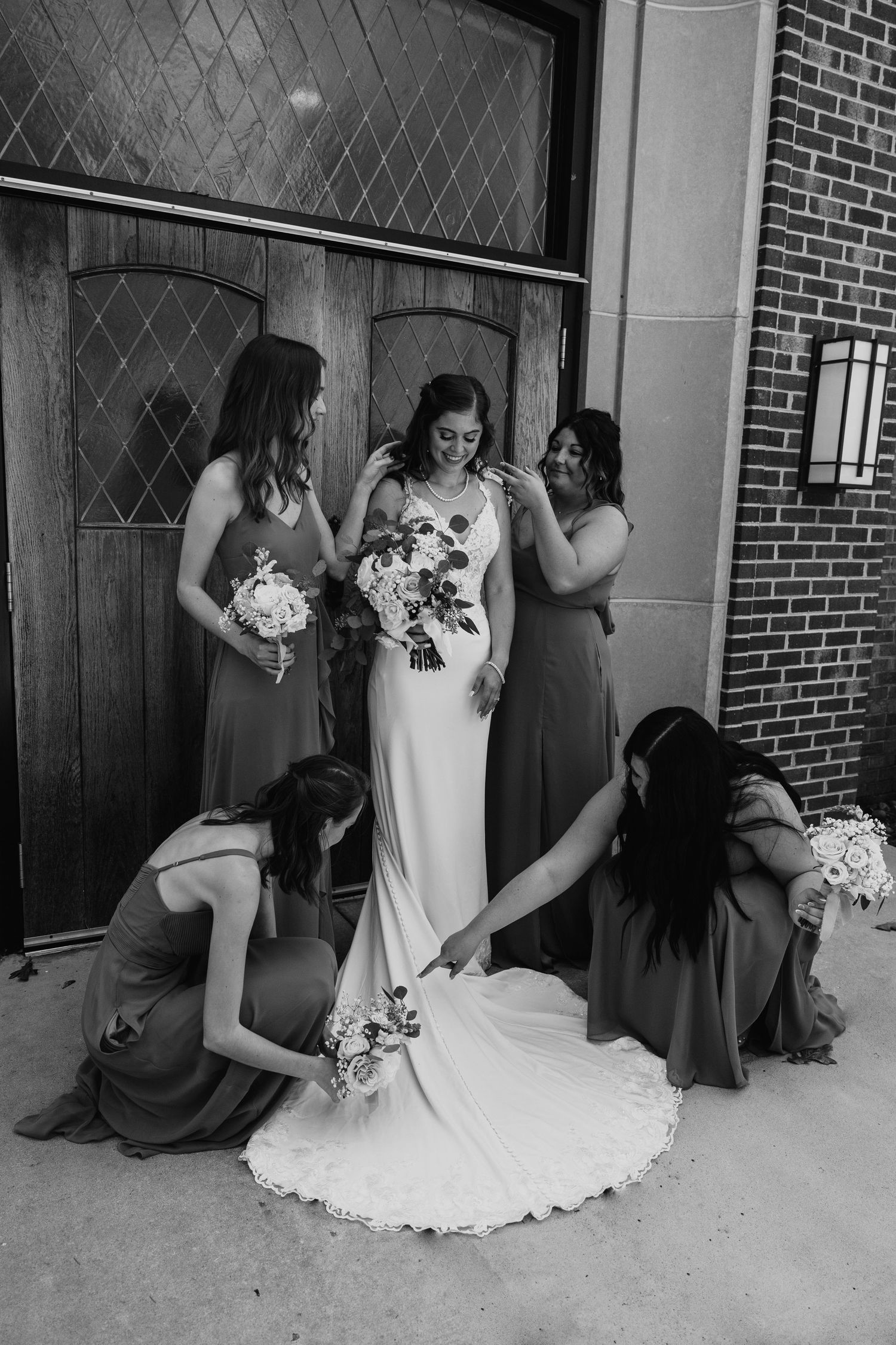Black and white wedding photos show candid moments between bridal party members.