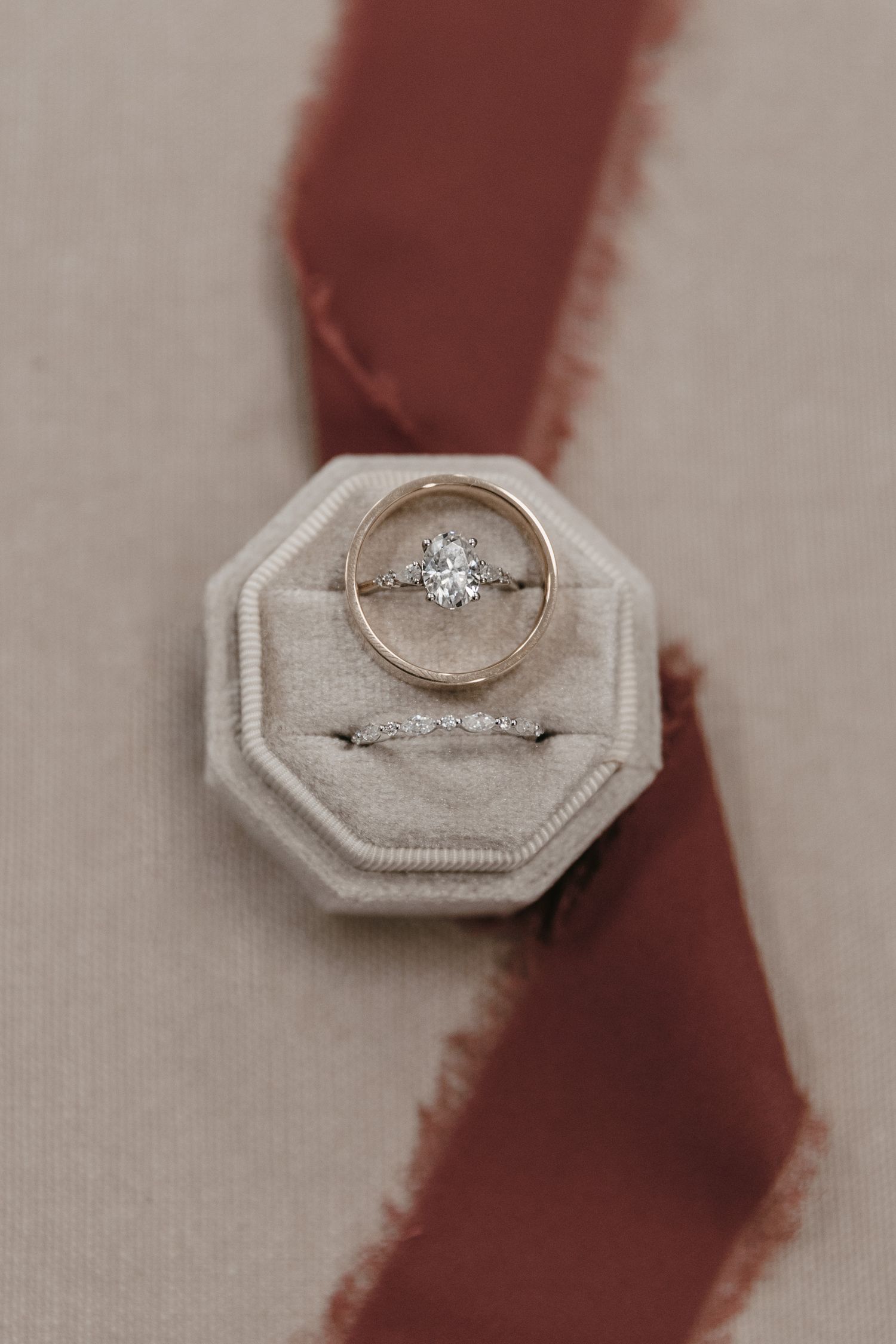 Diamond engagement ring displayed in a light gray ring box.
