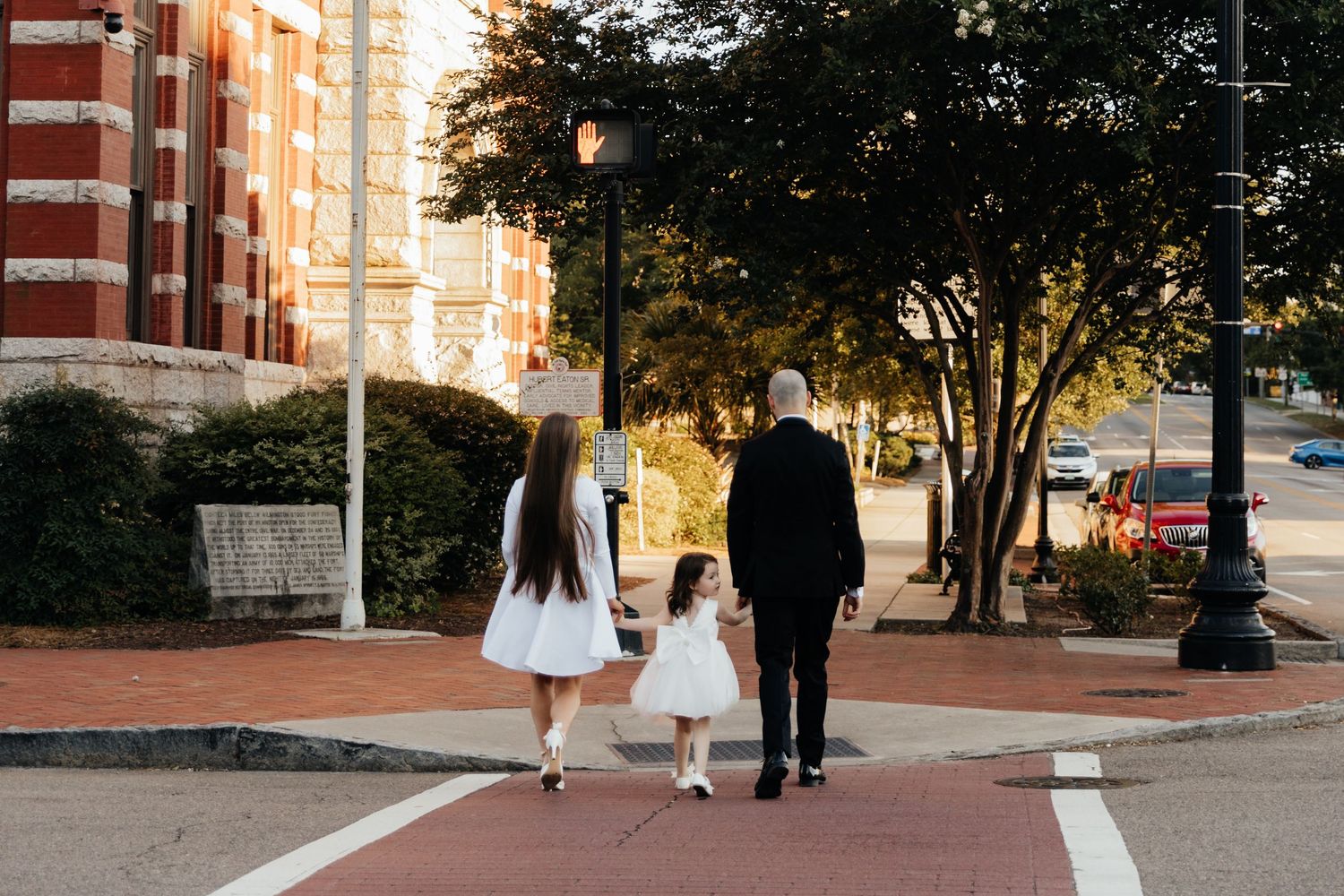 Family walking down the street during a downtown wedding.
