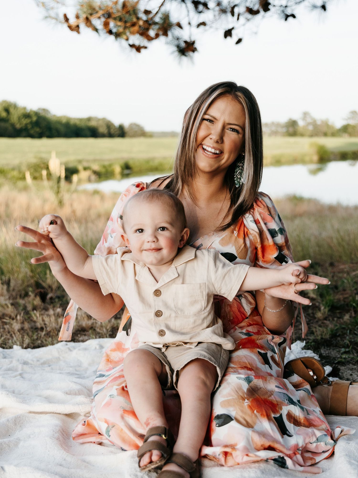 Family enjoying candid moments together during a sunny outdoor photoshoot.