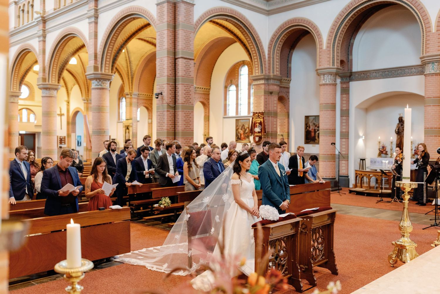 Traditional church wedding ceremony with arched architecture and gathered guests.