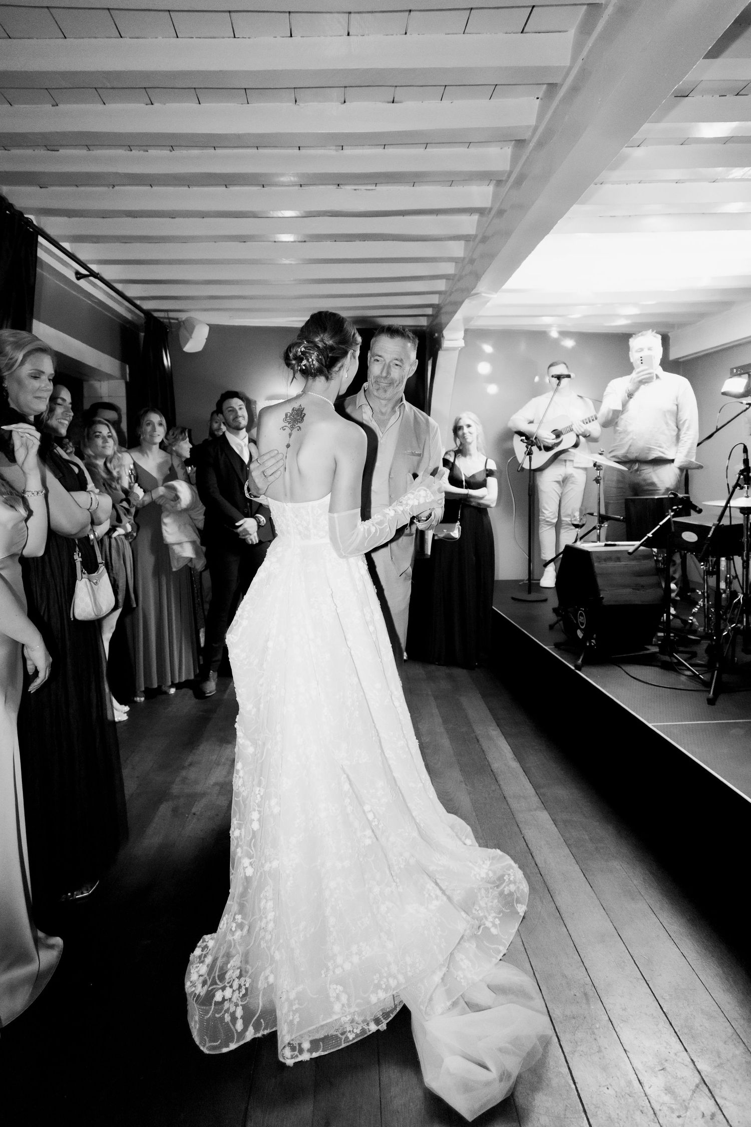 Black and white wedding reception photos showing dancing and celebration in an elegant indoor venue.